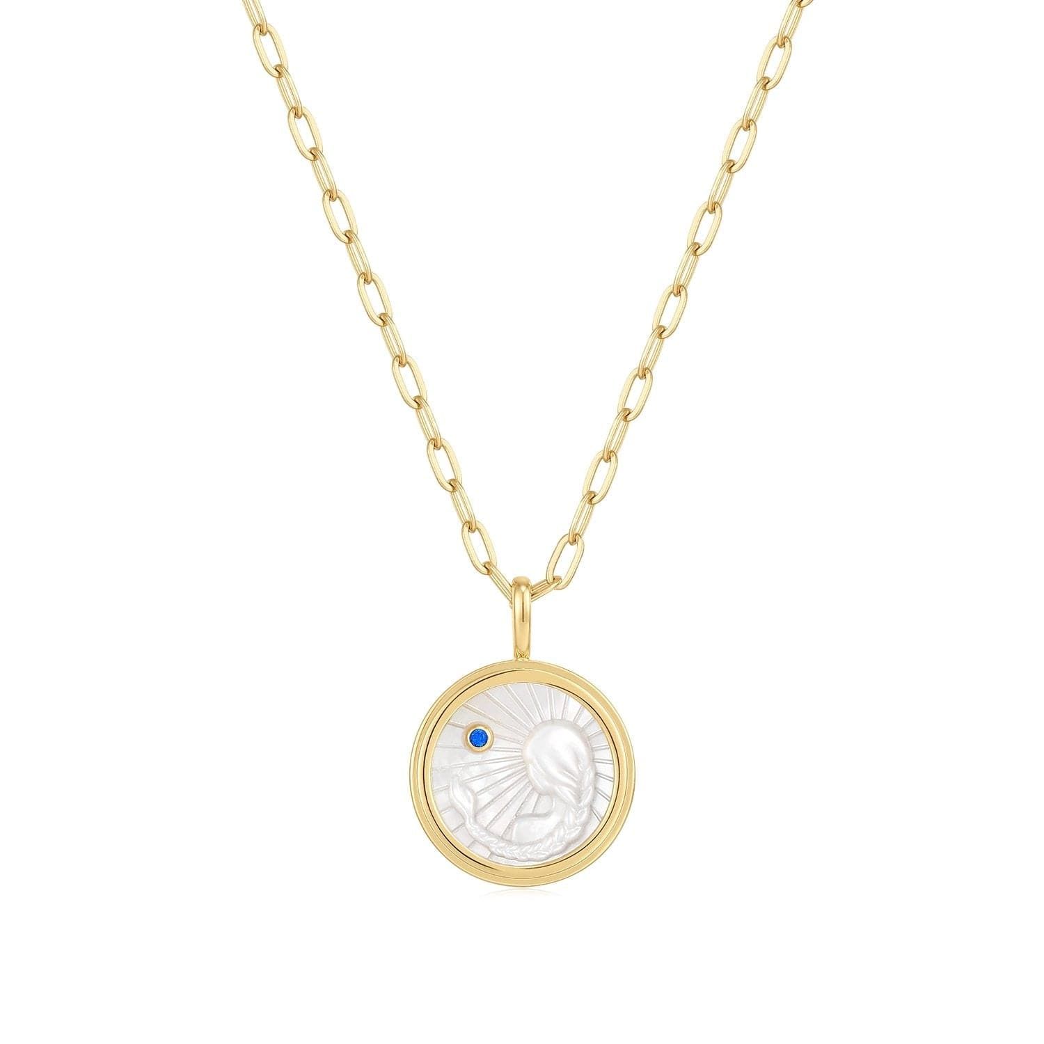 a gold necklace with a white shell on it
