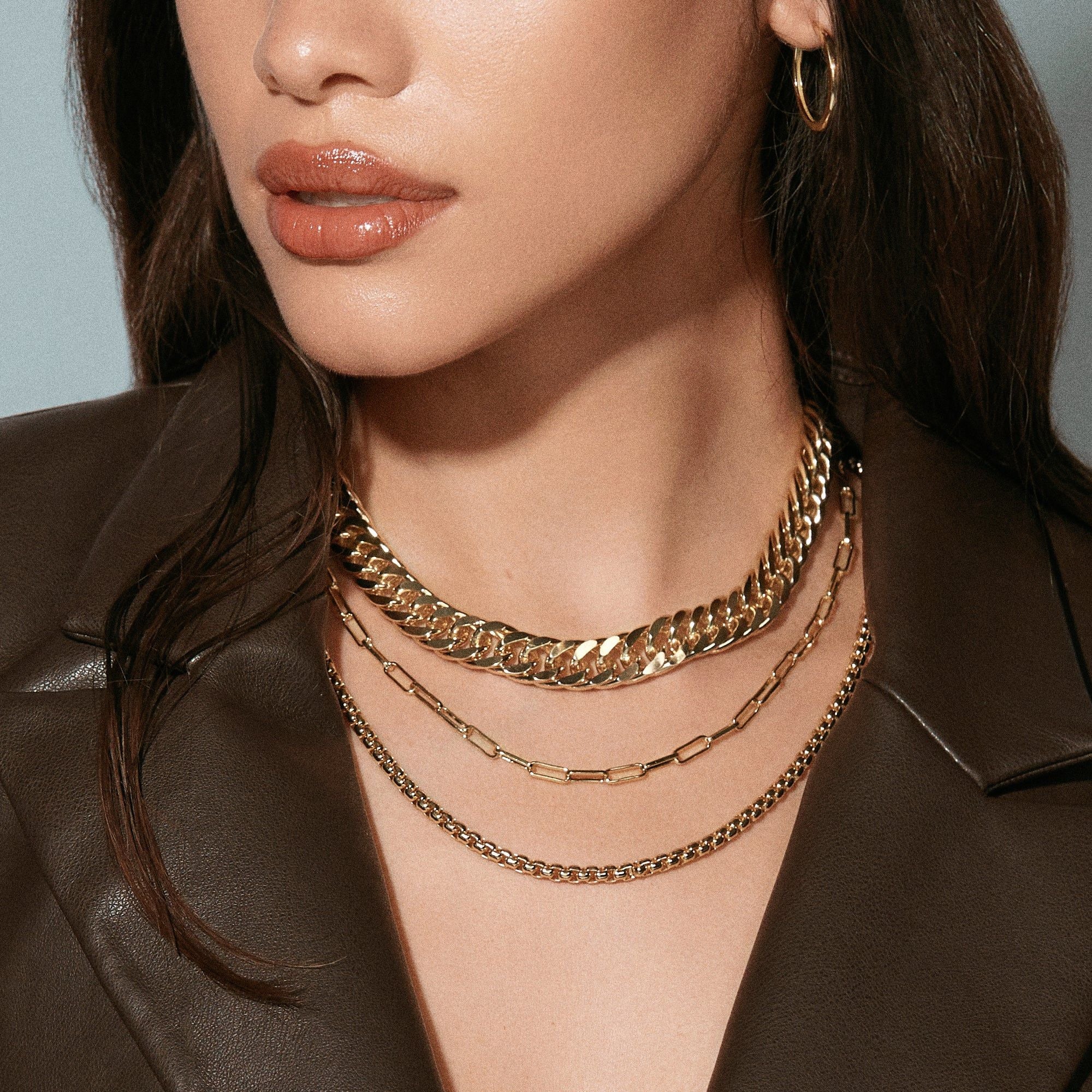 Layered gold necklaces from the Arya Necklace layering necklace collection with slinky curb chain