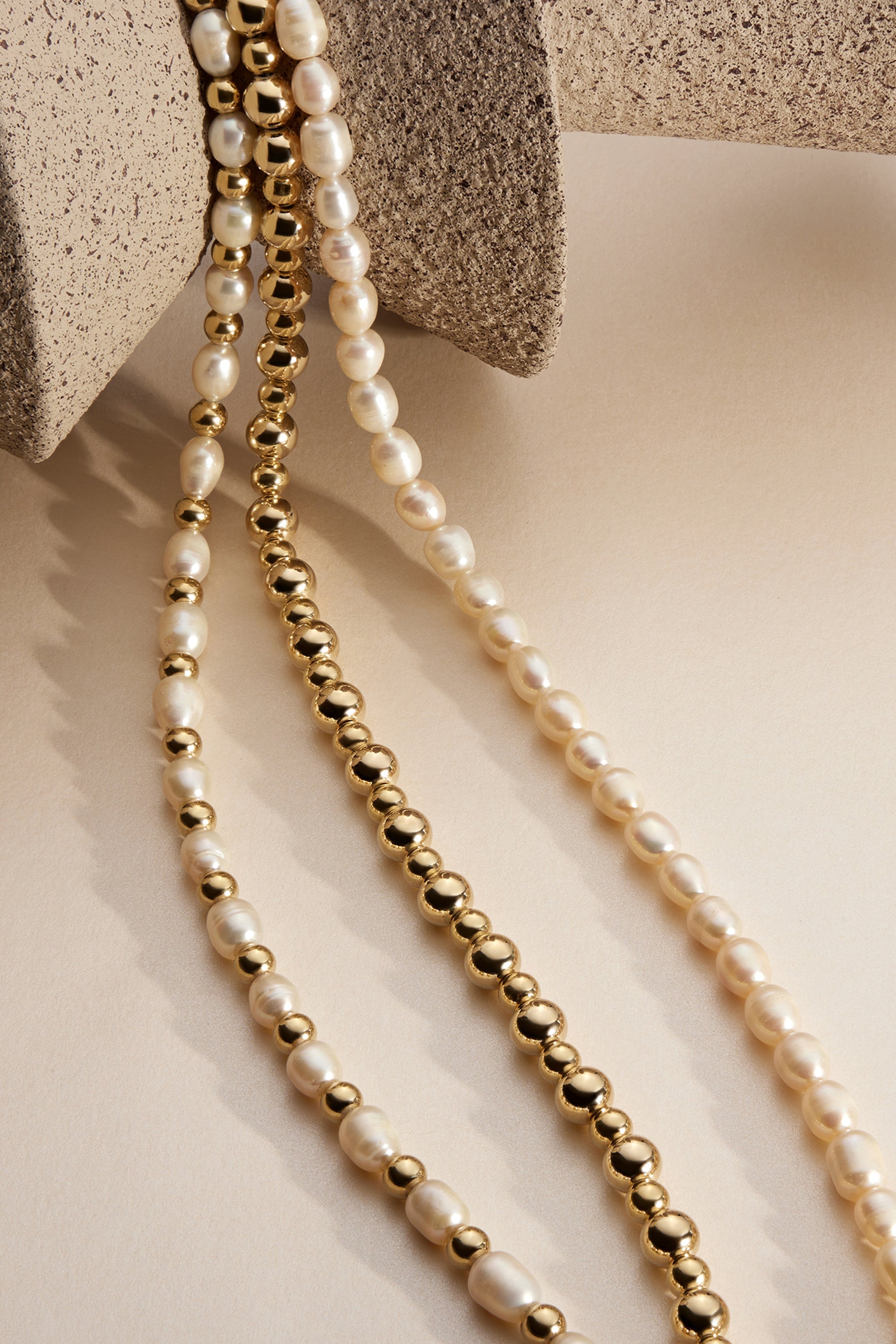 Elegant Beau Bead Necklace featuring three strands of pearl and gold beads for versatile styling