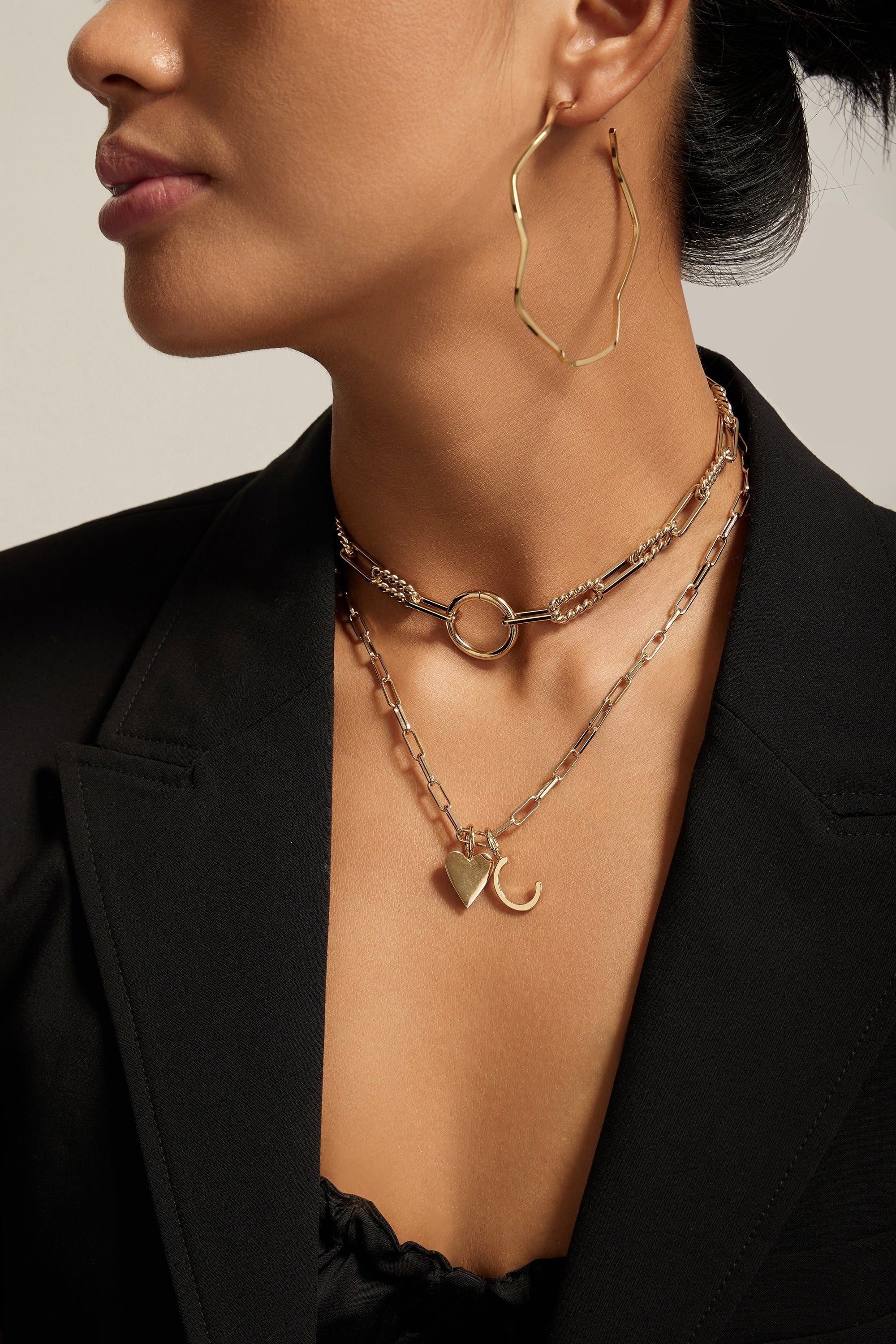 Woman showcasing the Cara Charm Necklace with a Small Helena Pendant and elongated link chain