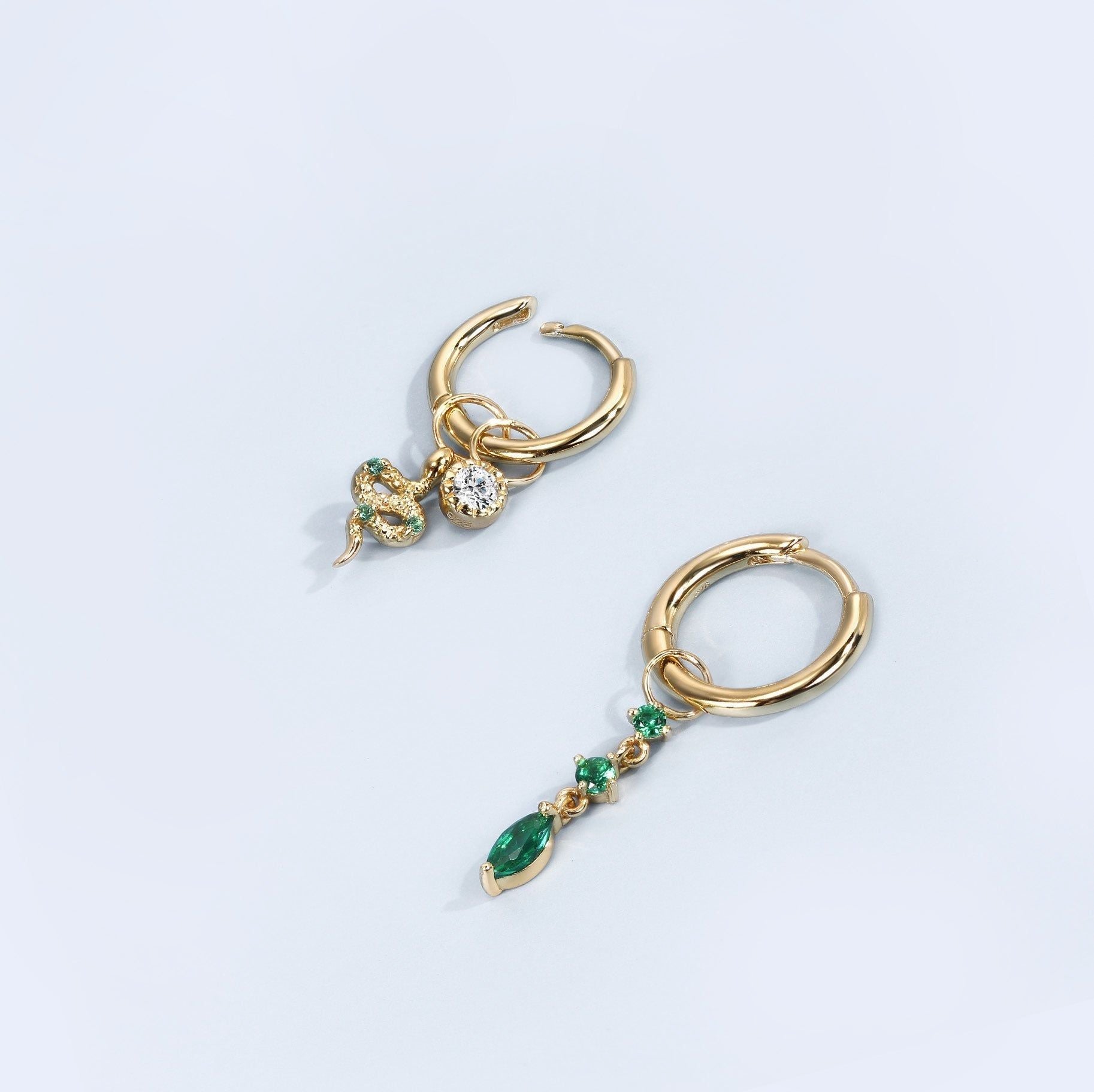 Two gold hoop earrings with gemstone charms from the Demi-Fine Collection featuring a Snake Hoop Charm