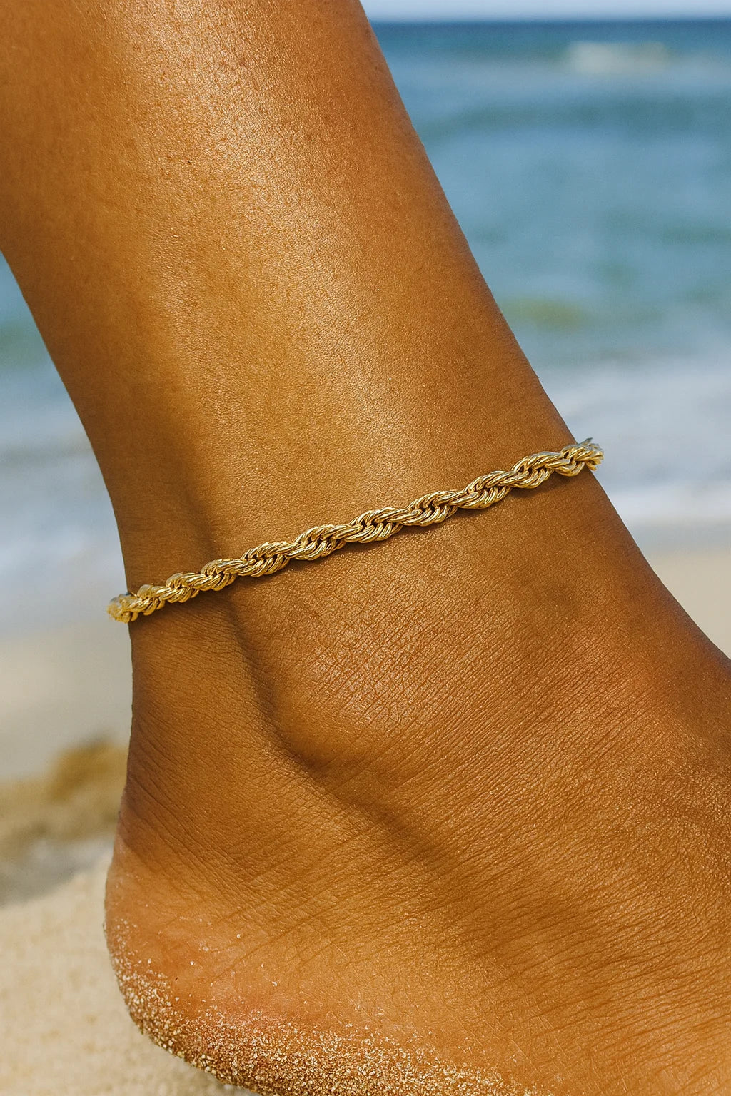 Golden rope chain anklet on a tanned ankle for Rosa Anklet product display