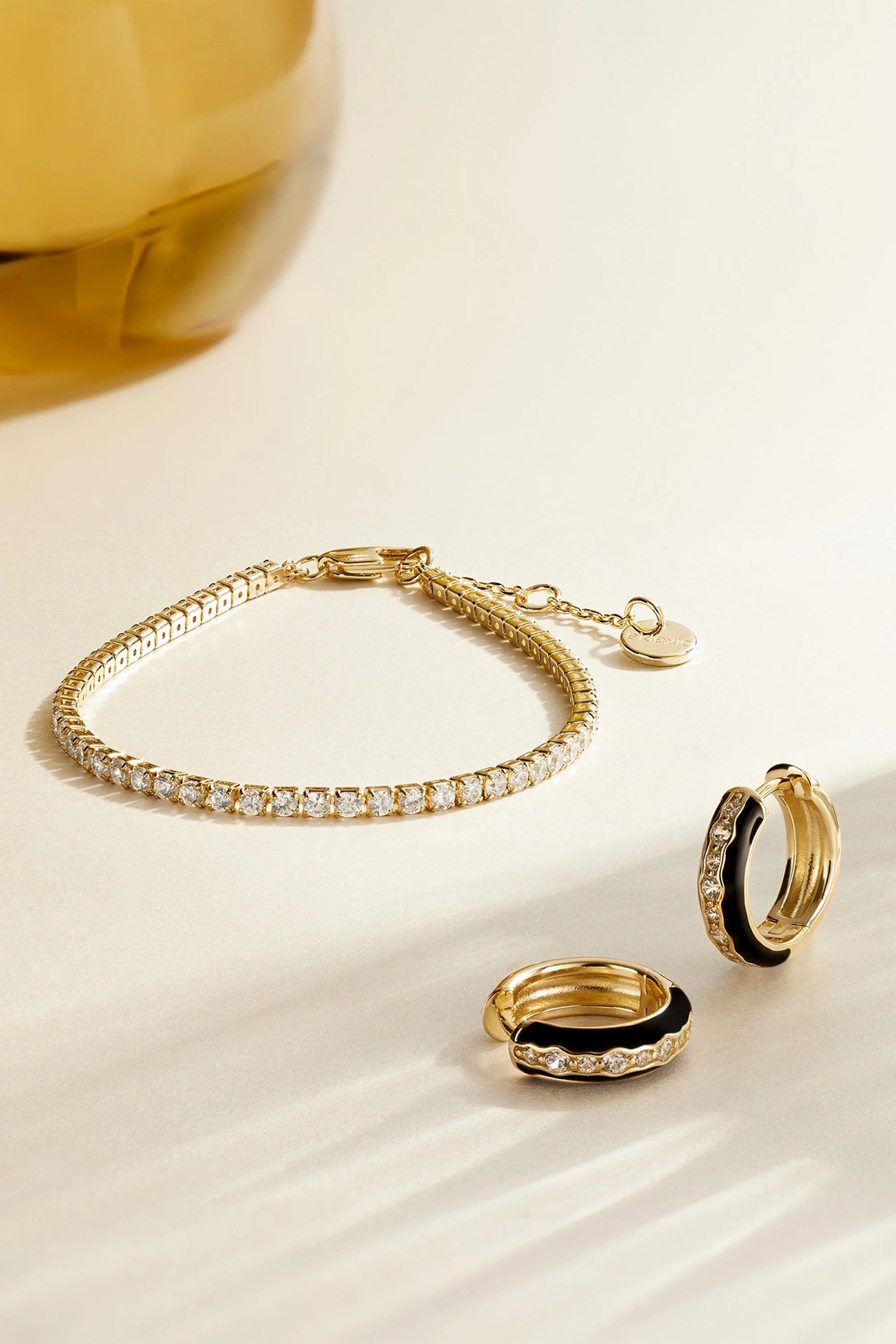 Shiny Gold Bracelet and Hoop Earrings on the Classic CZ Tennis Bracelet product display
