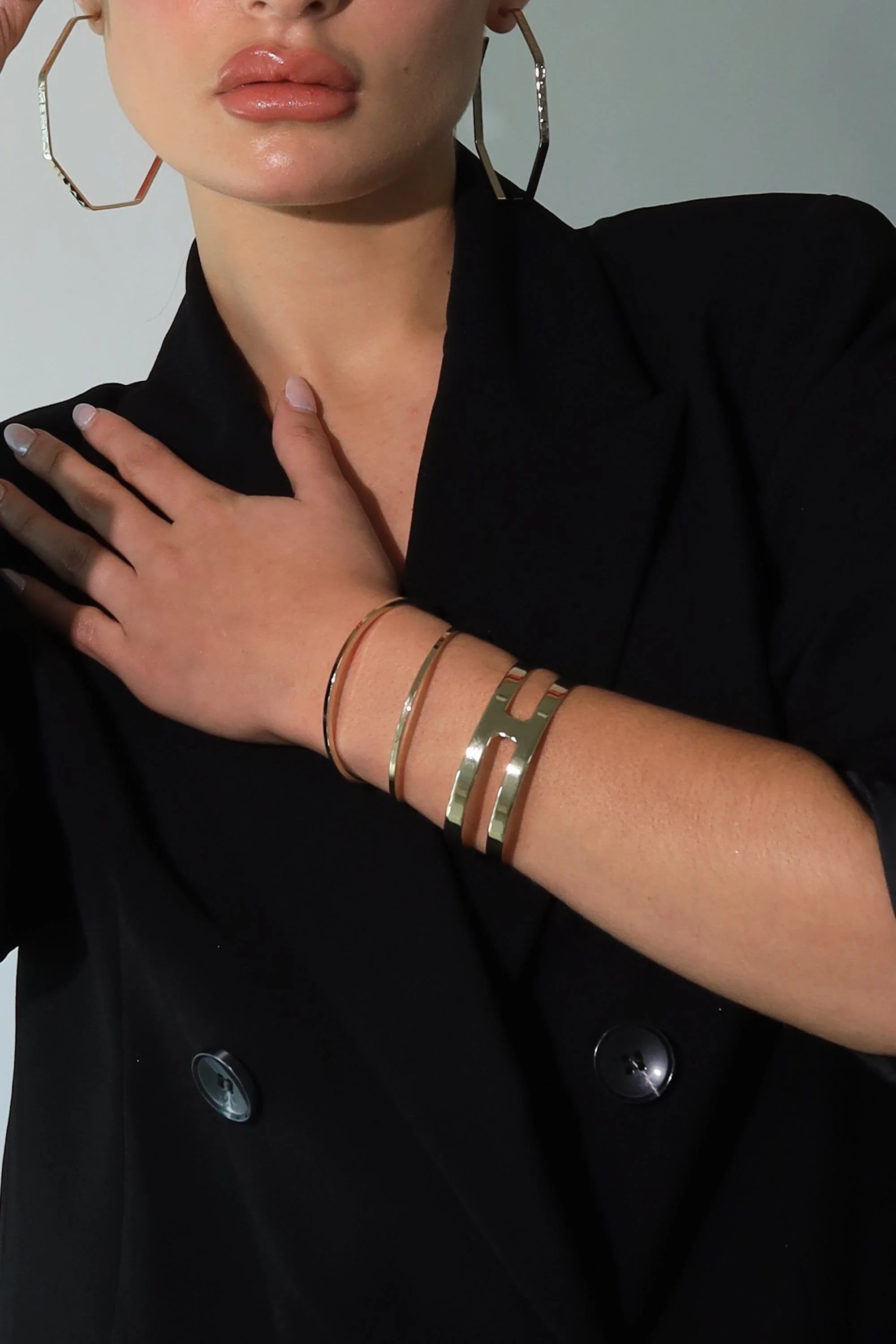 Woman wearing stylish gold Rectangle Cut-Out Cuff Bracelet for a chic look