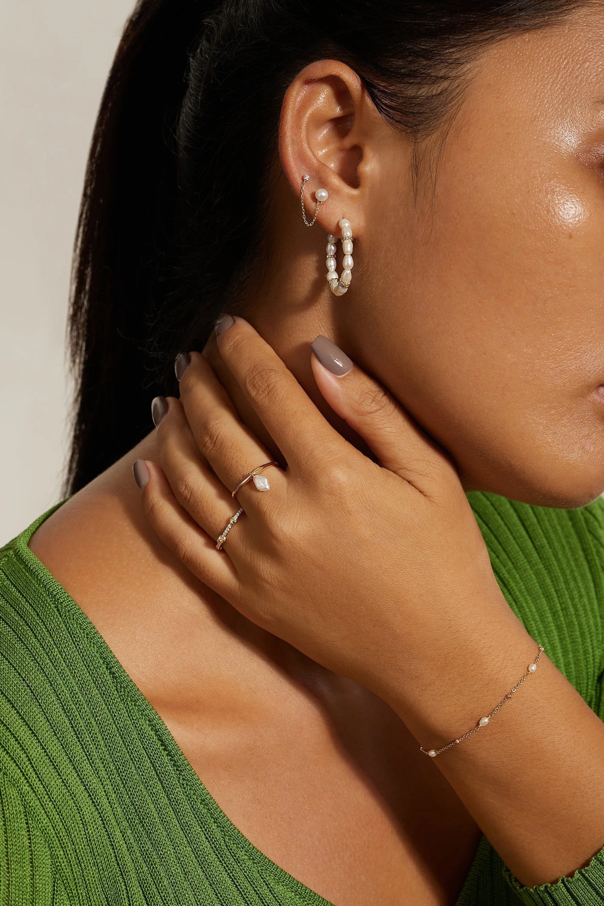 Woman wearing stylish Double CZ and Pearl Chain Link Earrings with pearl jewelry