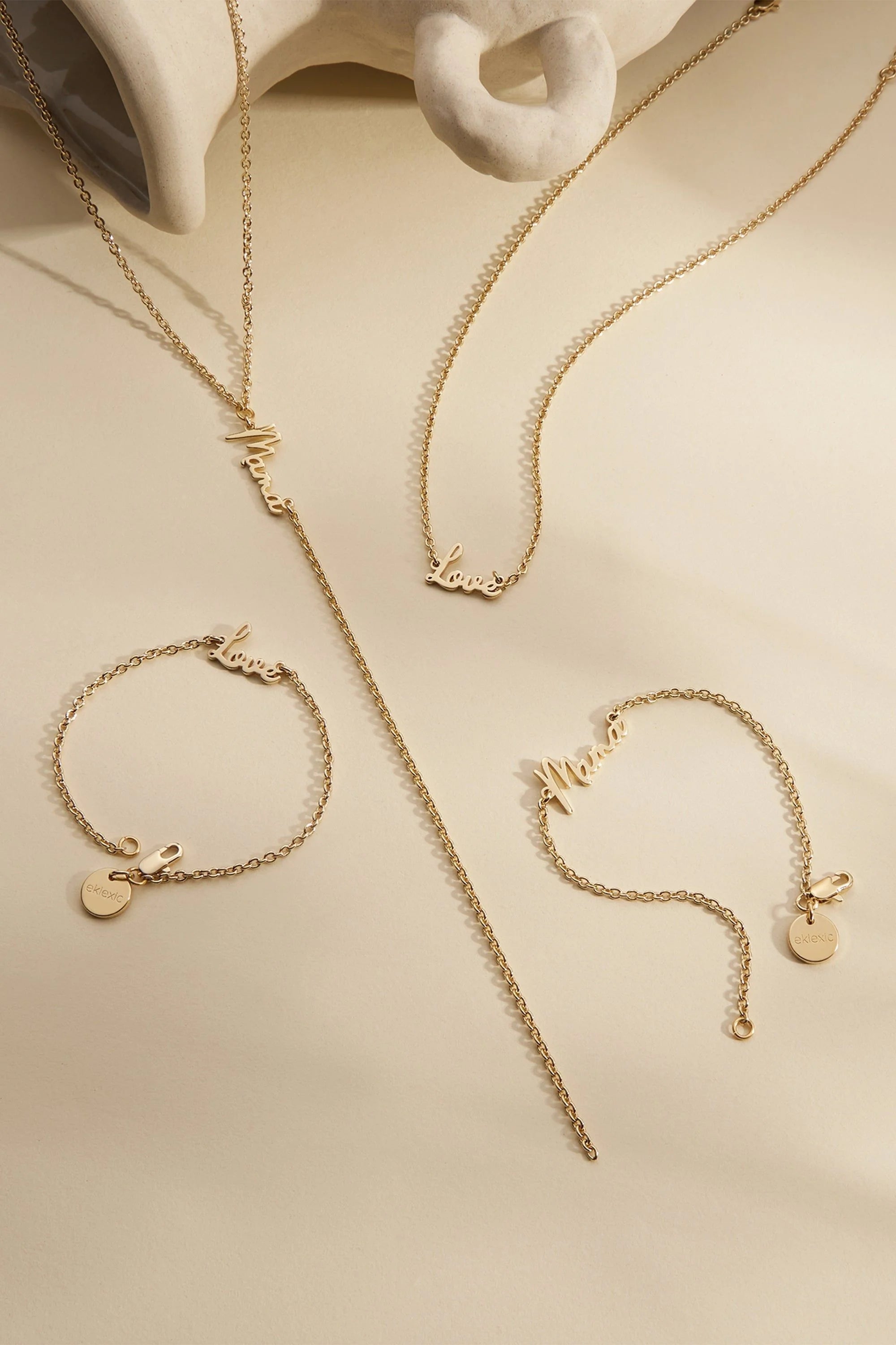 Gold-toned jewelry set featuring the Dainty Script Mama Lariat Necklace