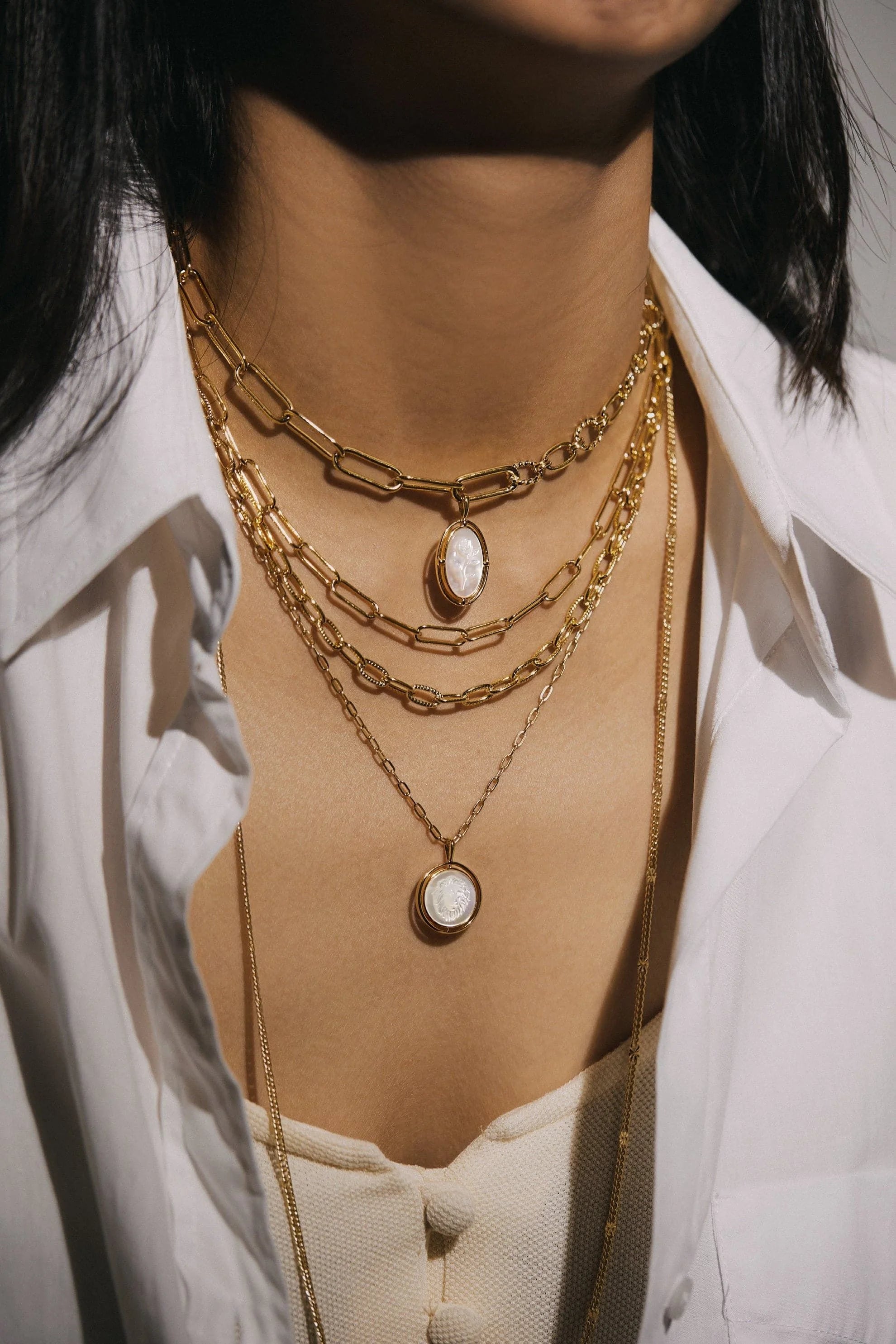 Layered gold necklaces with Mother Of Pearl Lion Pendants for a stylish look