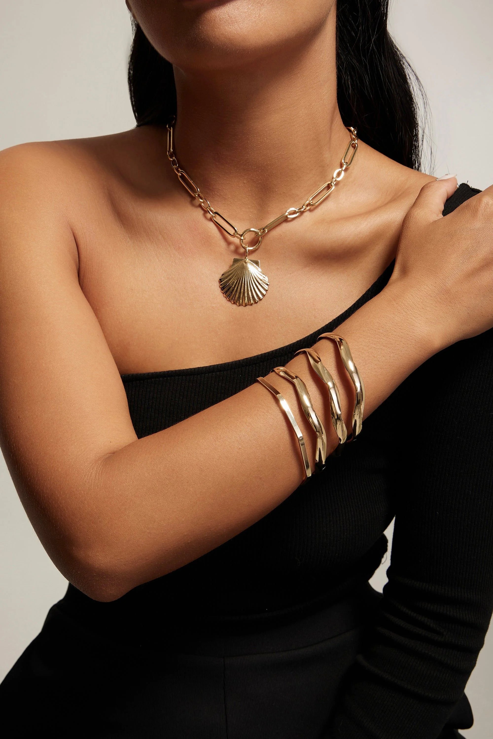 Gold seashell necklace and bracelets from the Shelly Necklace collection