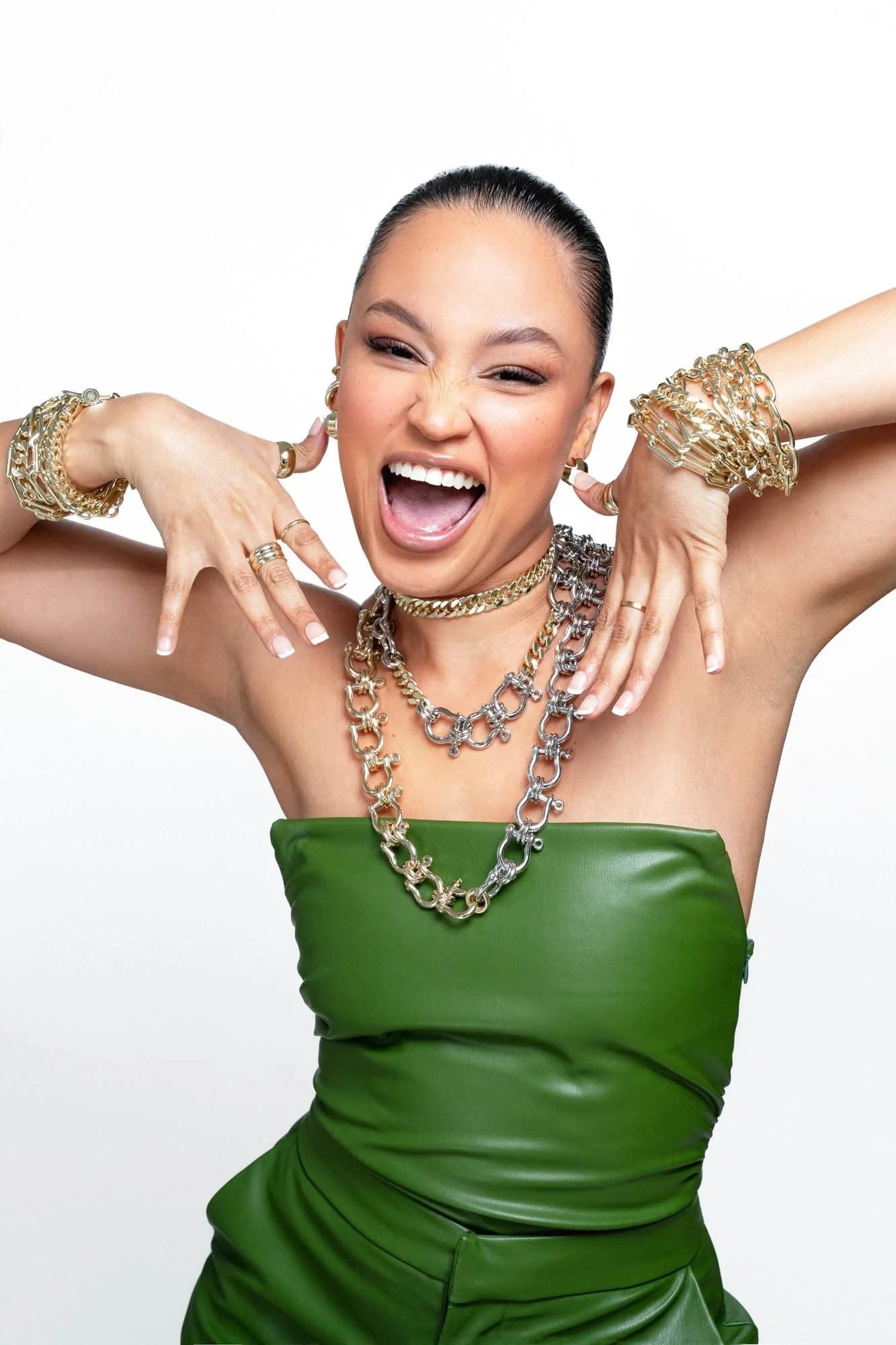 Enthusiastic woman wearing the stylish Two Toned Hendrick Necklace with gold jewelry