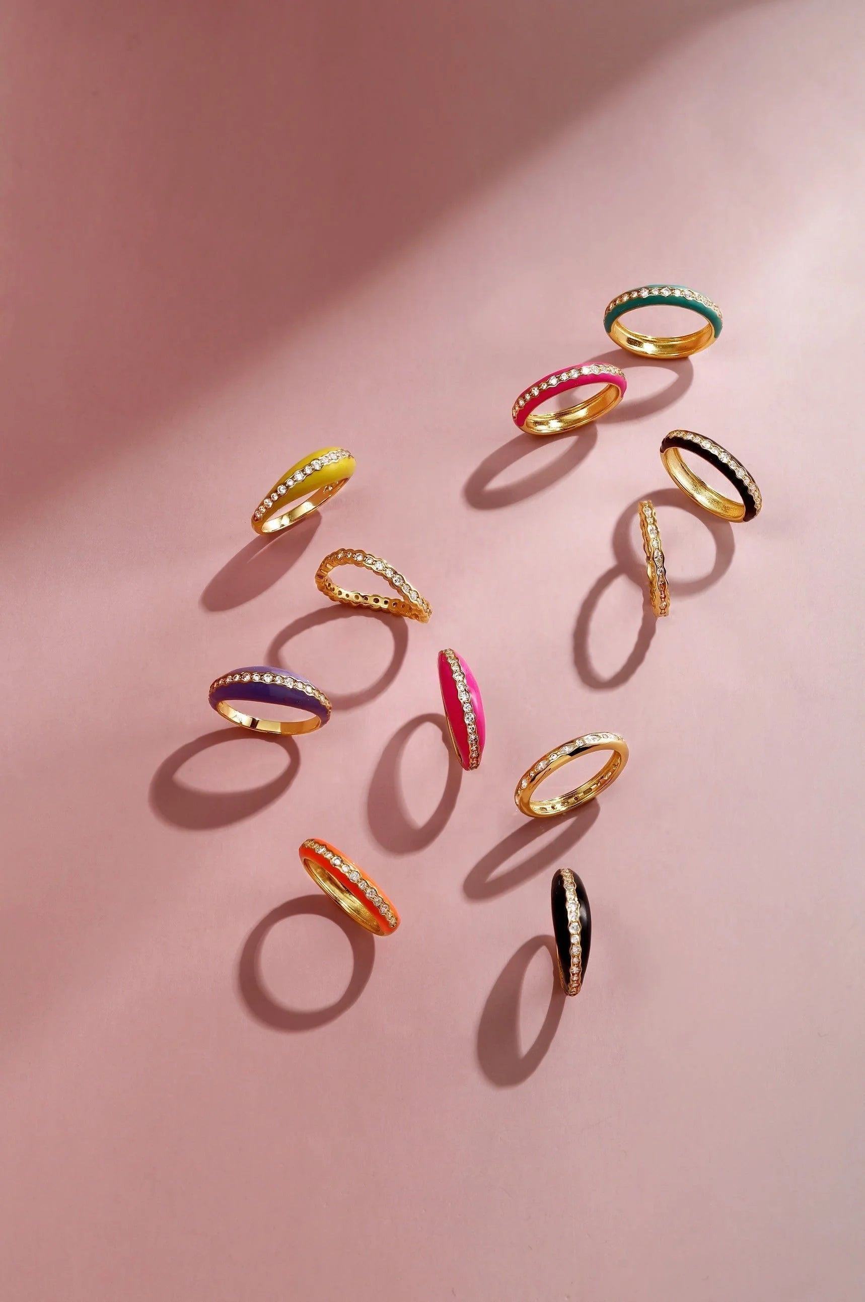 Colorful enamel and diamond rings in a Thin Black Enamel and CZ Channel Ring display