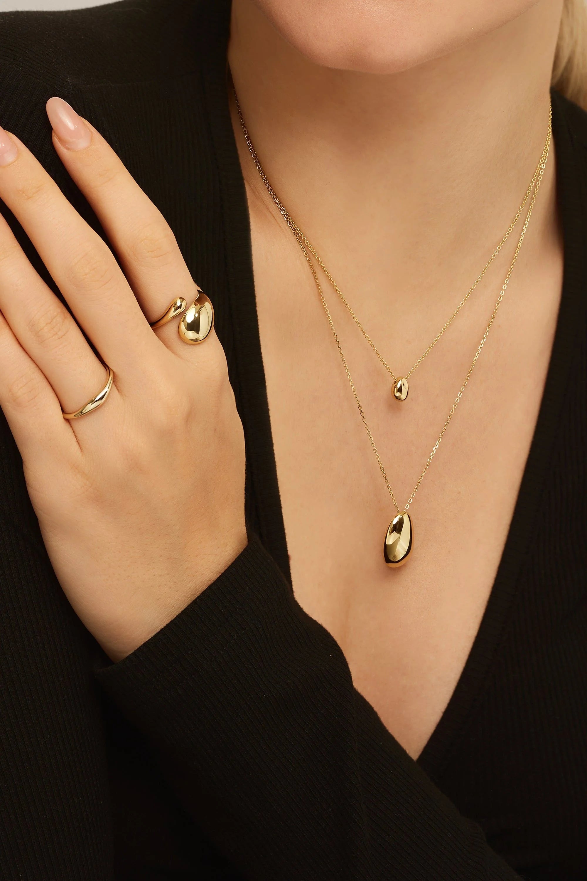 Gold layered necklaces with teardrop pendants and matching rings on Wren Ring product