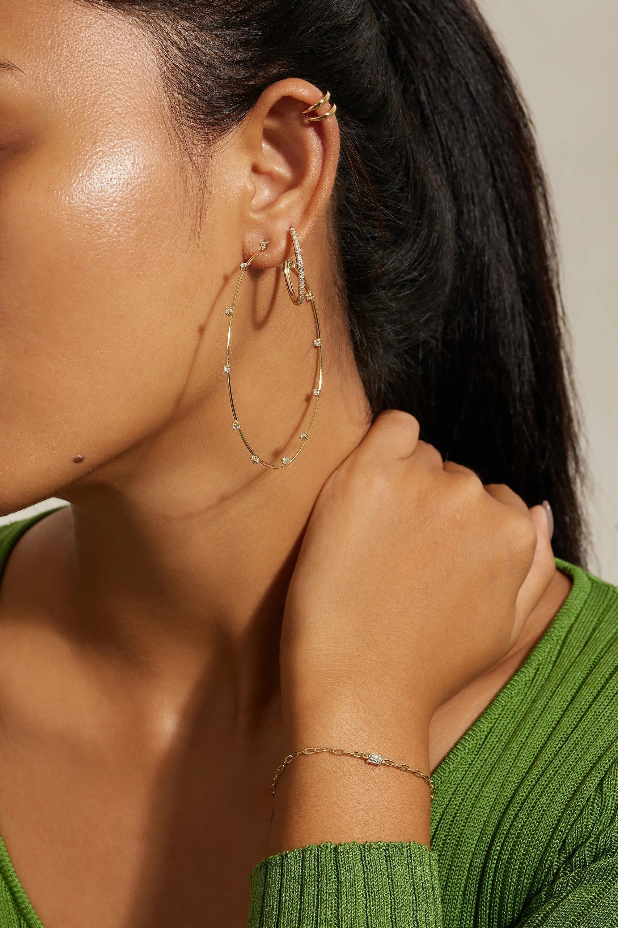 Gold hoop earrings and bracelet featuring Medium CZ Huggie Hoop Earrings for stylish accessories