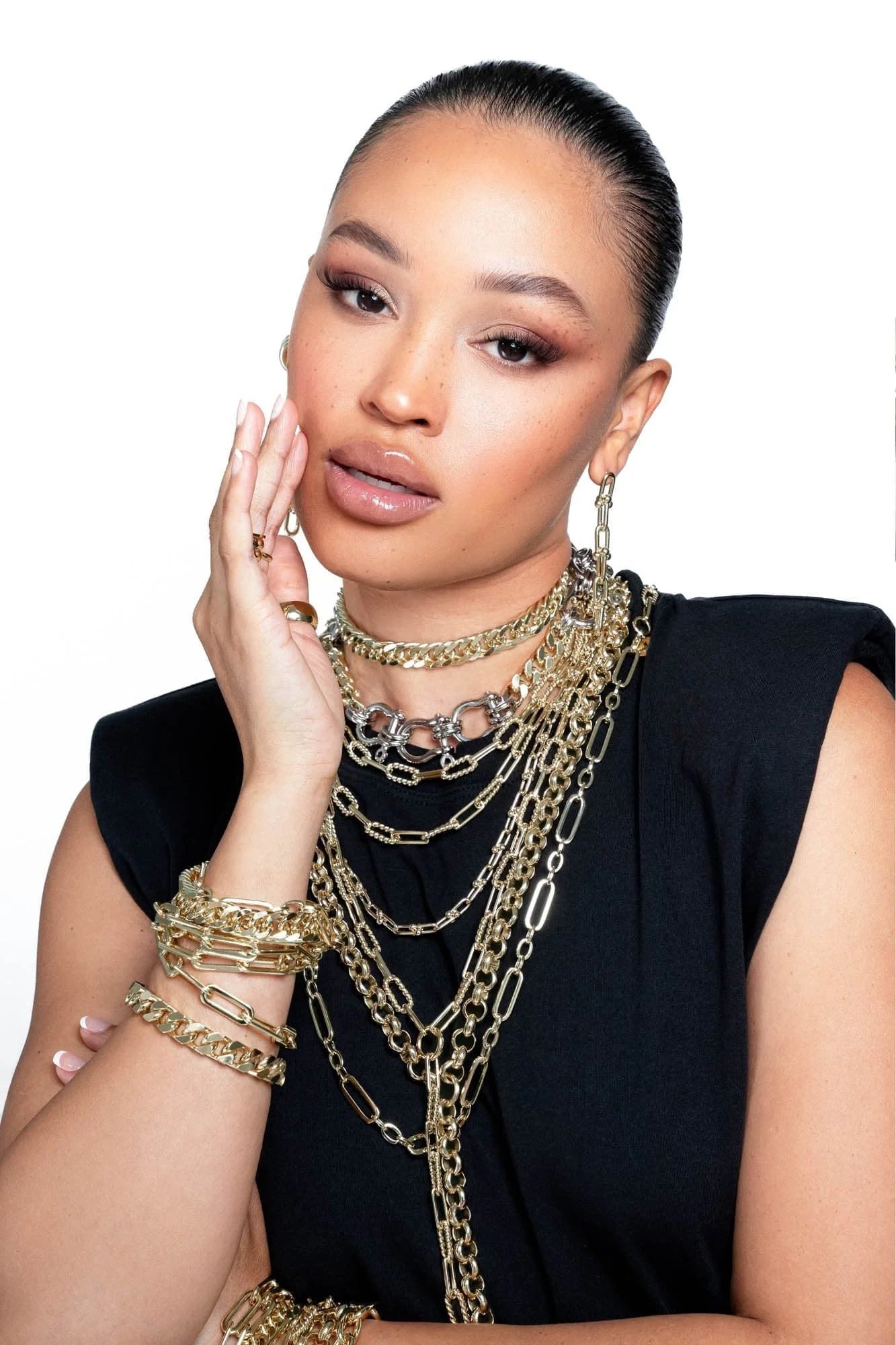 Woman wearing Royal Rolo Chain Lariat gold jewelry showcasing elegant luxury