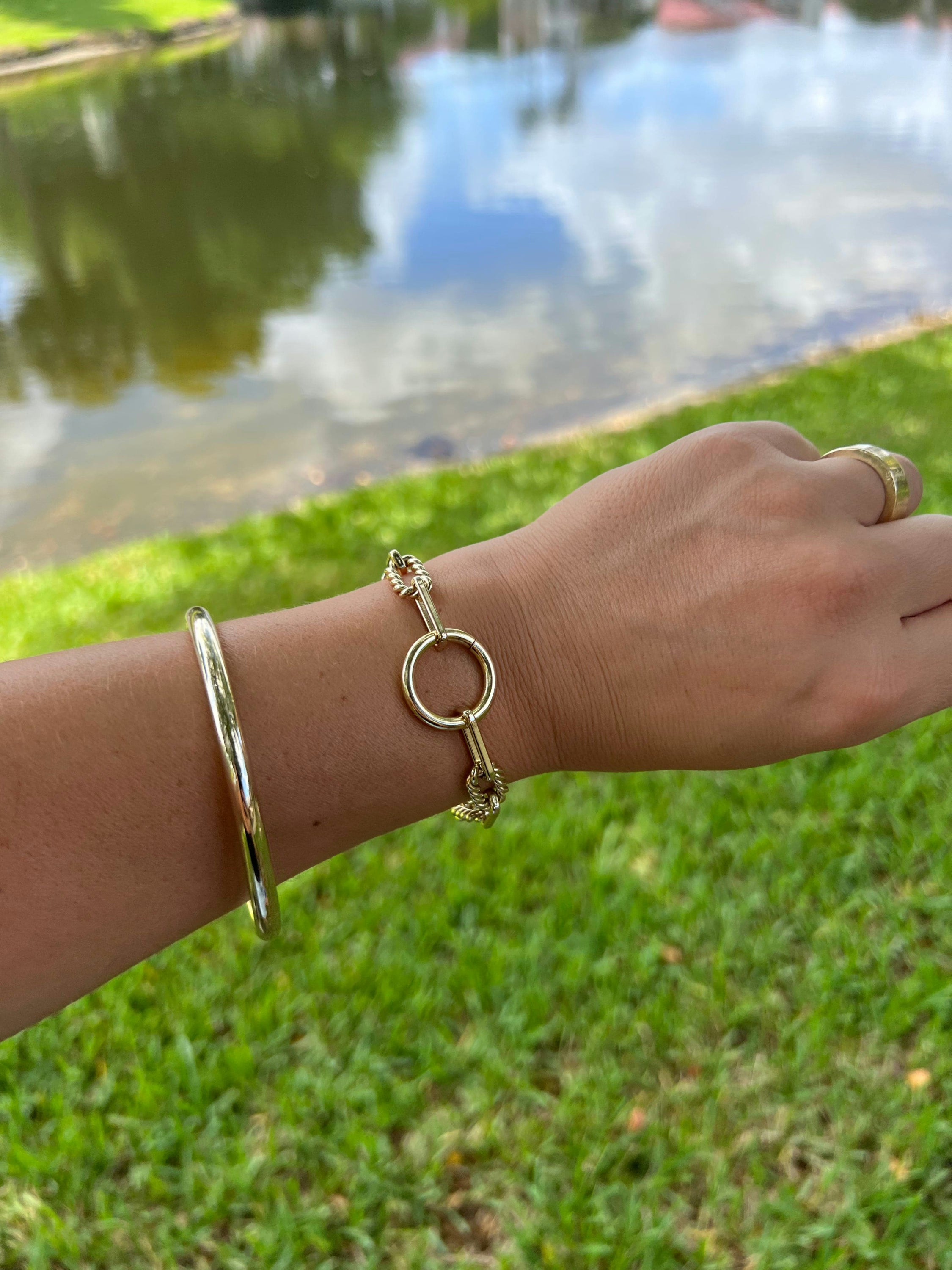 Gold Eliza Bracelet with twisted link design made of recycled brass on wrist