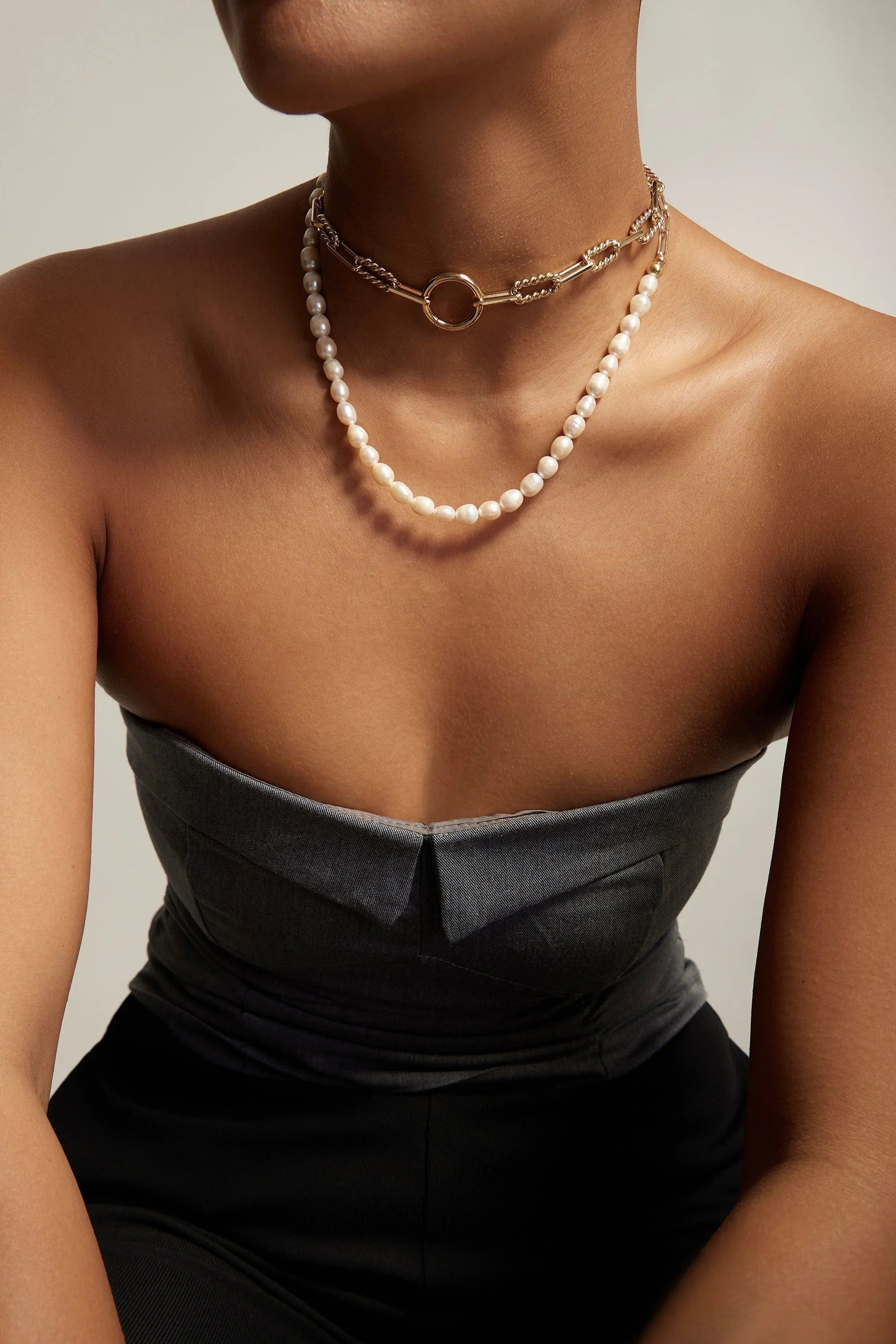 Woman wearing two layered necklaces from the Eliza Necklace collection
