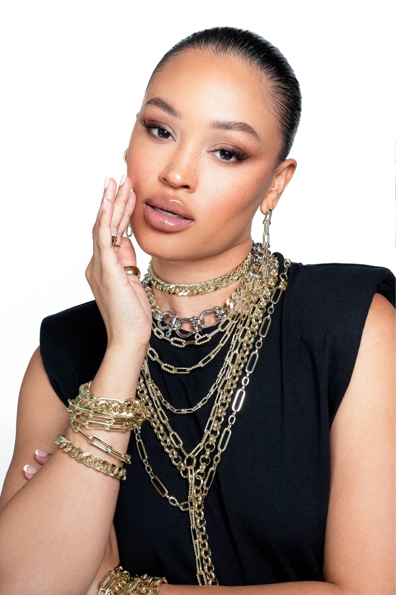 Woman wearing Enzo Double Layer Necklace with alternating twisted link chains and bracelets
