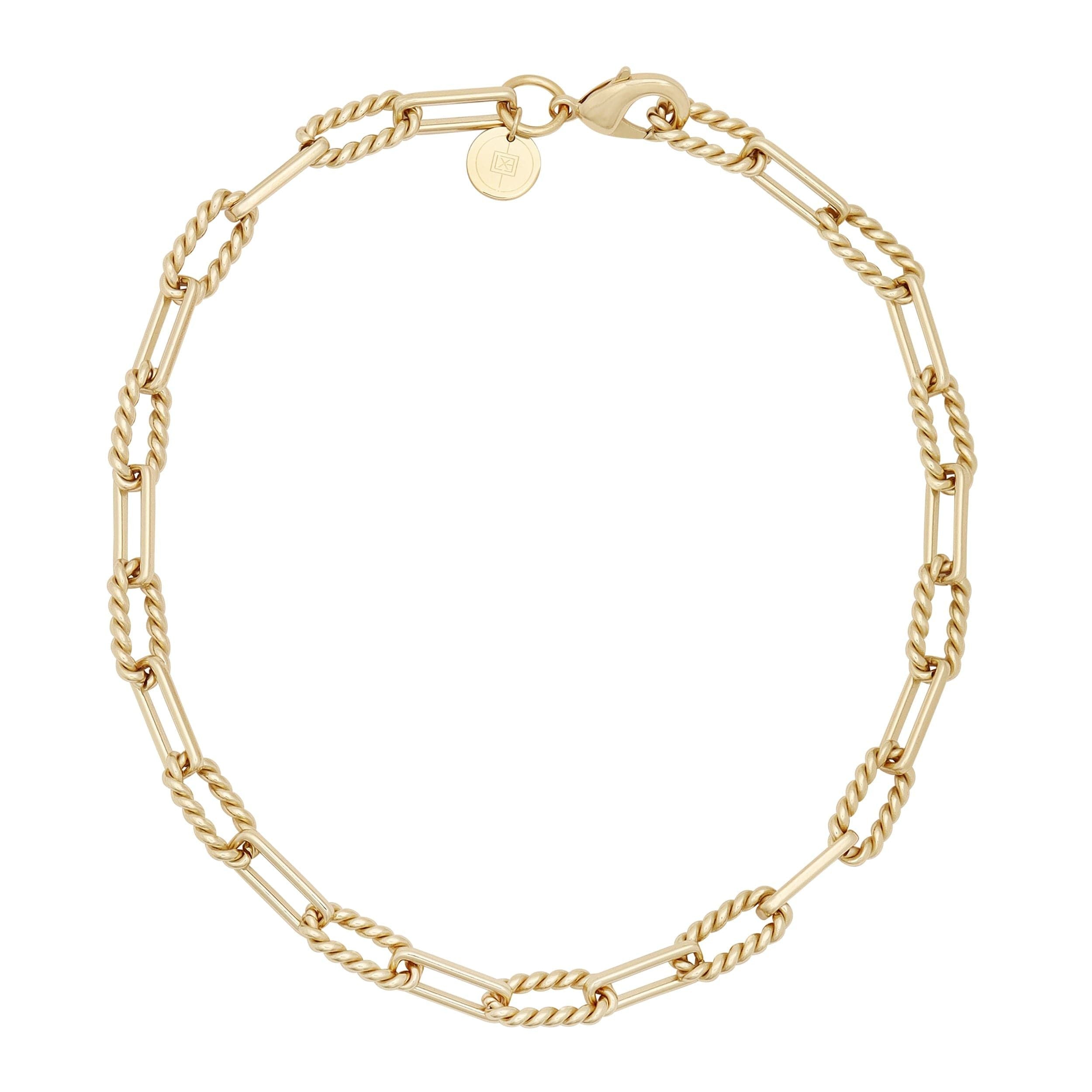 Gold chain-link bracelet showcasing the luxurious Enzo Necklace with alternating twisted link design