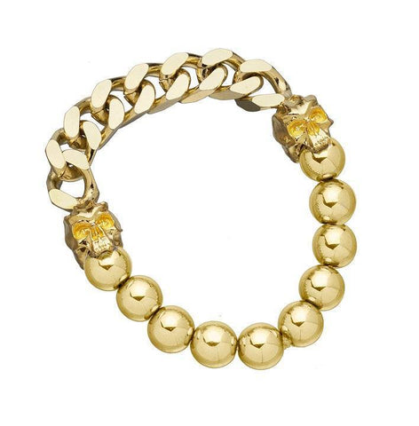 Gold-toned chain and beaded bracelet with skull accents worn by Adrienne Bailon.