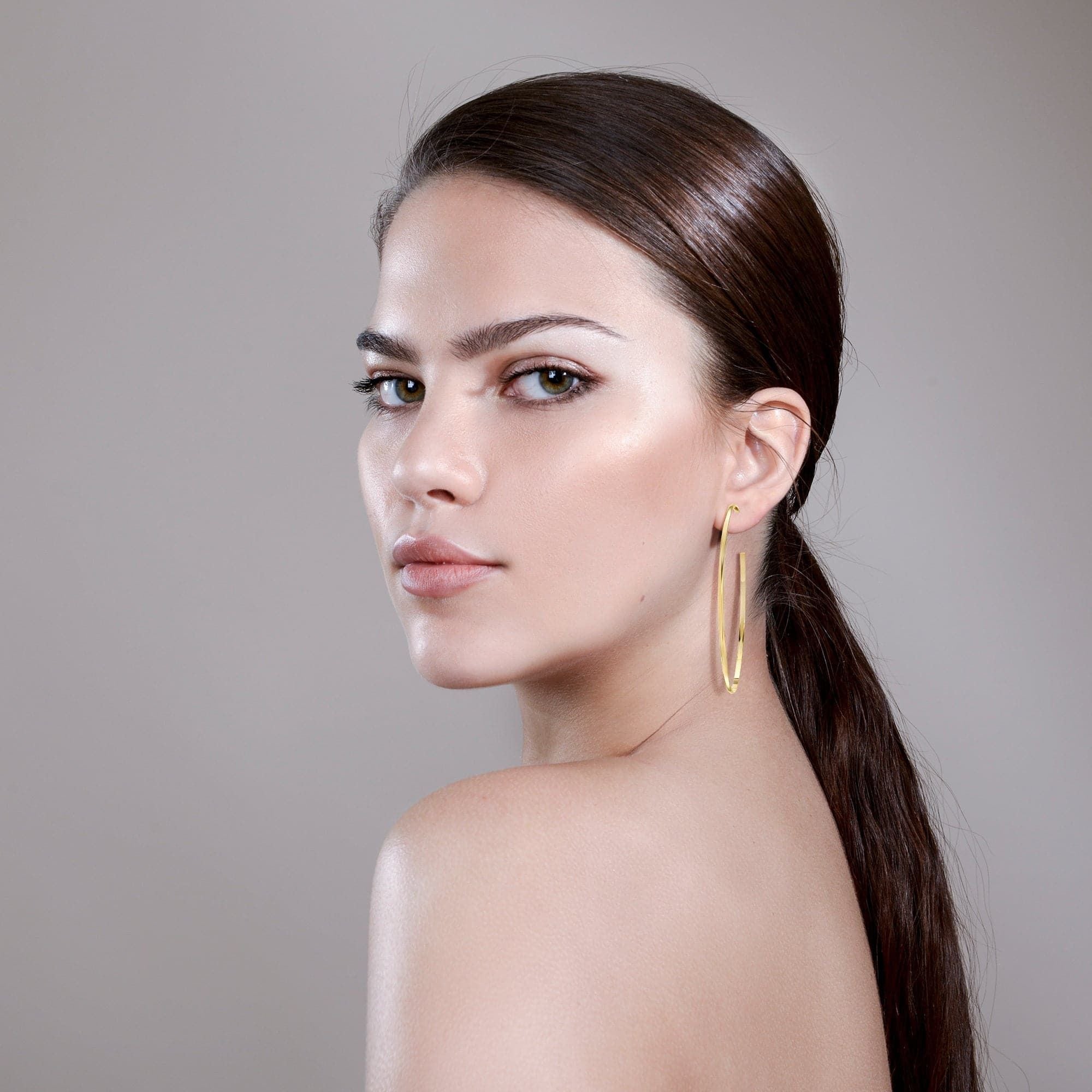 Elegant woman wearing Hannah Hoops, featuring a domed shape and measuring perfectly