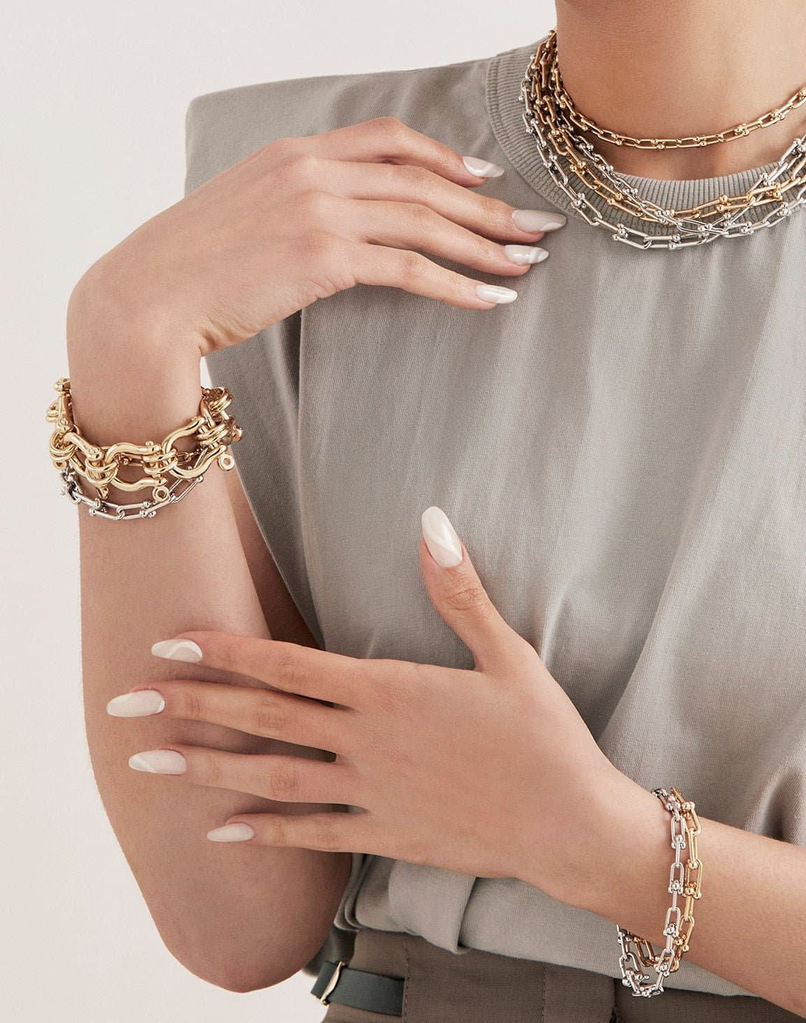 Woman showcasing the Harrison Bracelet, an incredible statement piece in gold and silver