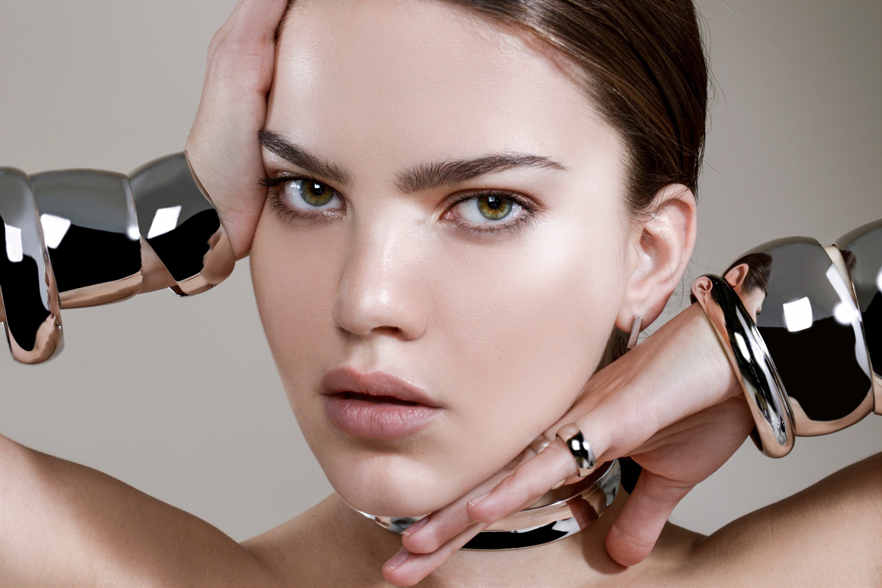 Woman modeling a Large Domed Bangle crafted from recycled brass with elegant shine