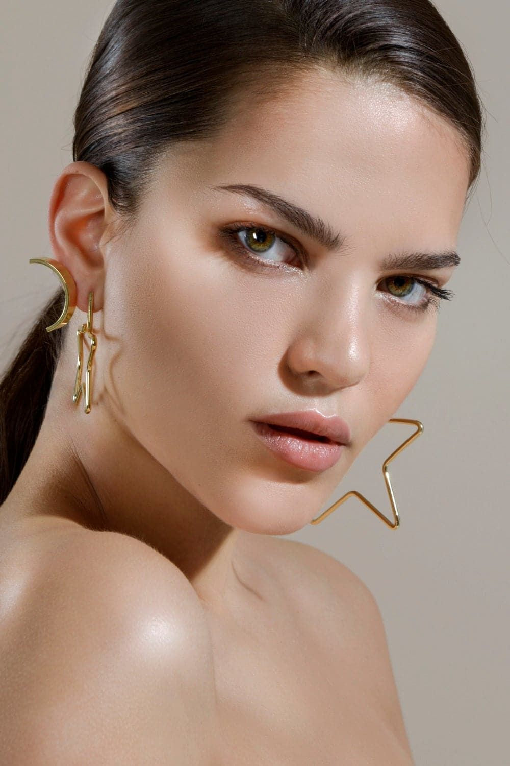 Woman showcasing Large Full Star Earrings in 14k yellow gold jewelry