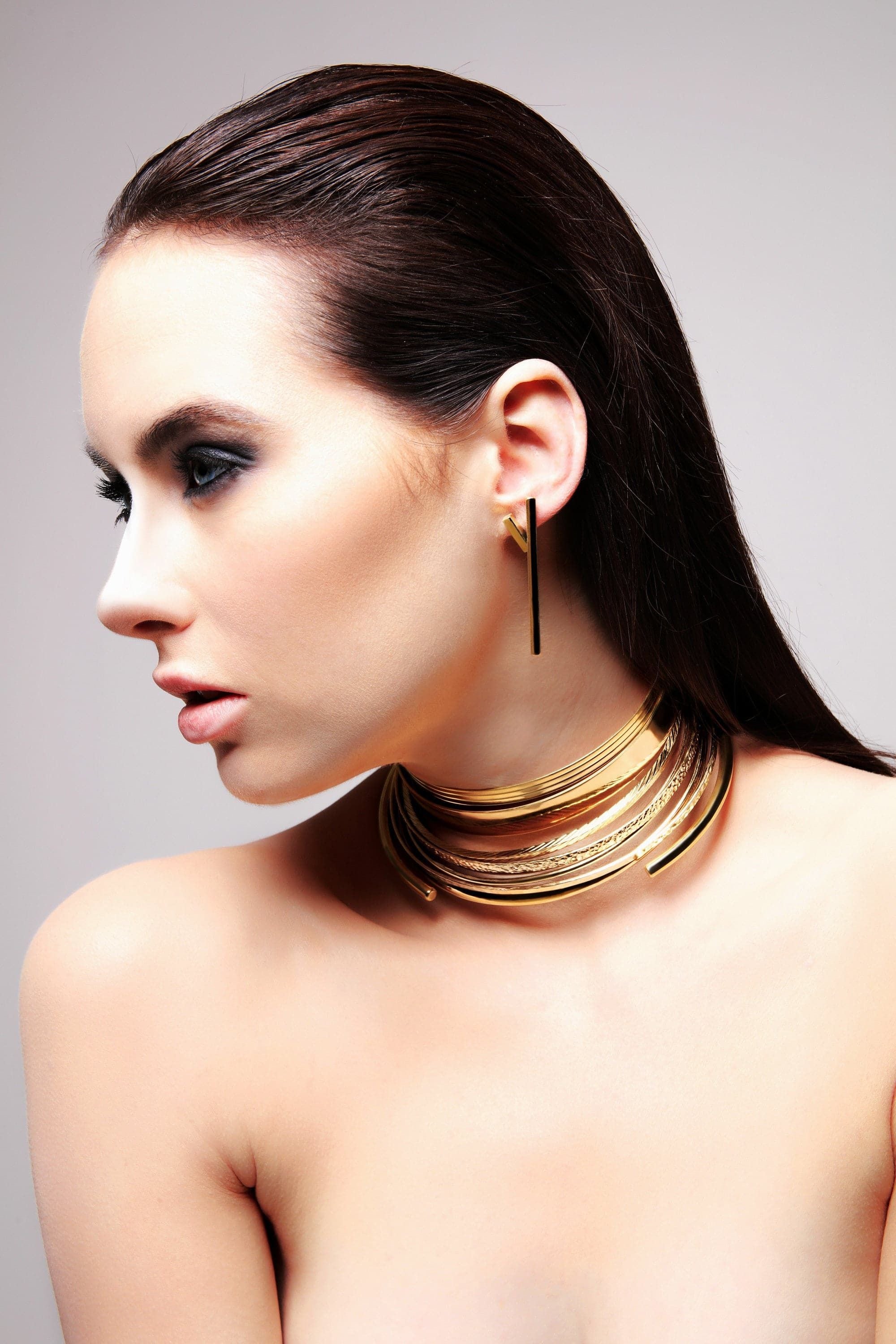 Woman modeling Large Stick Earrings with 14k yellow gold choker and black earrings