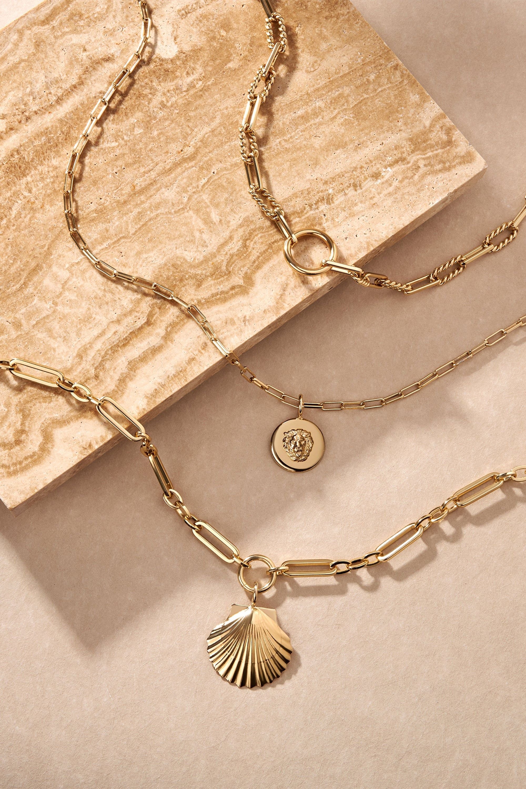 Gold-toned layered necklaces featuring a Leni Lion Pendant crafted from recycled brass