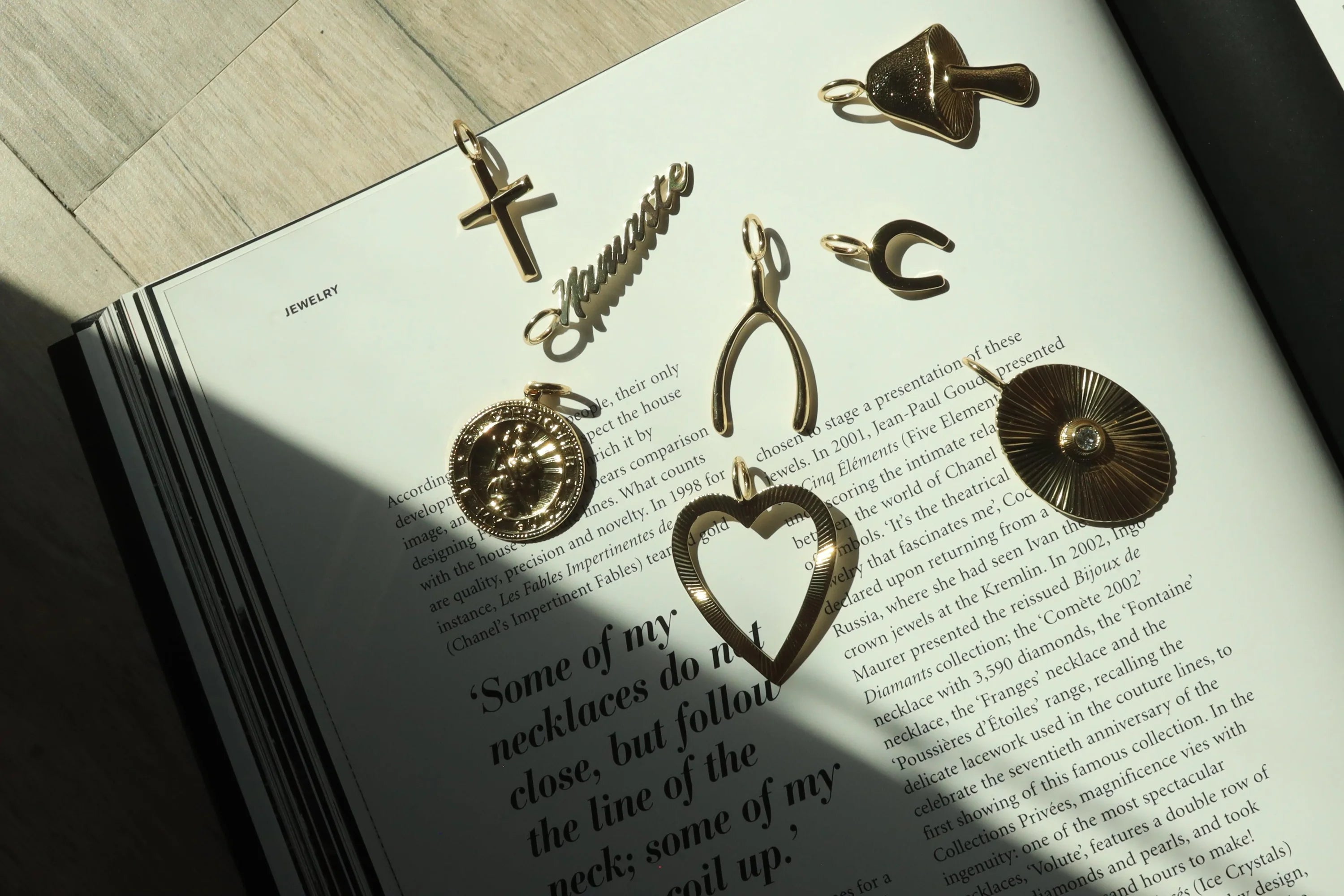 Gold-toned charm pendants in recycled brass finishes on ecoat wishbone pendant measuring charm