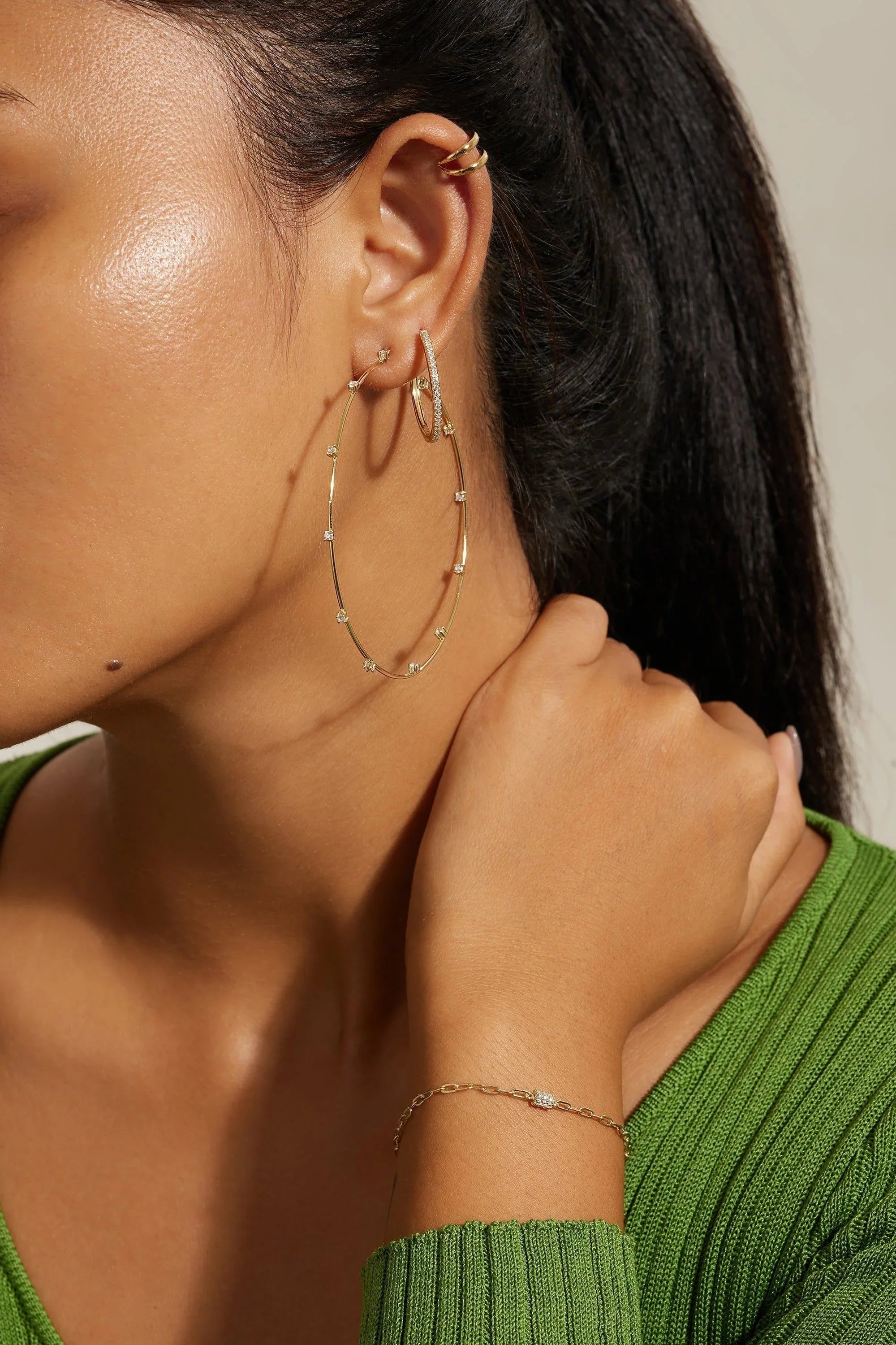 Gold hoop earrings and bracelet from Medium CZ Huggie Hoop Earrings collection