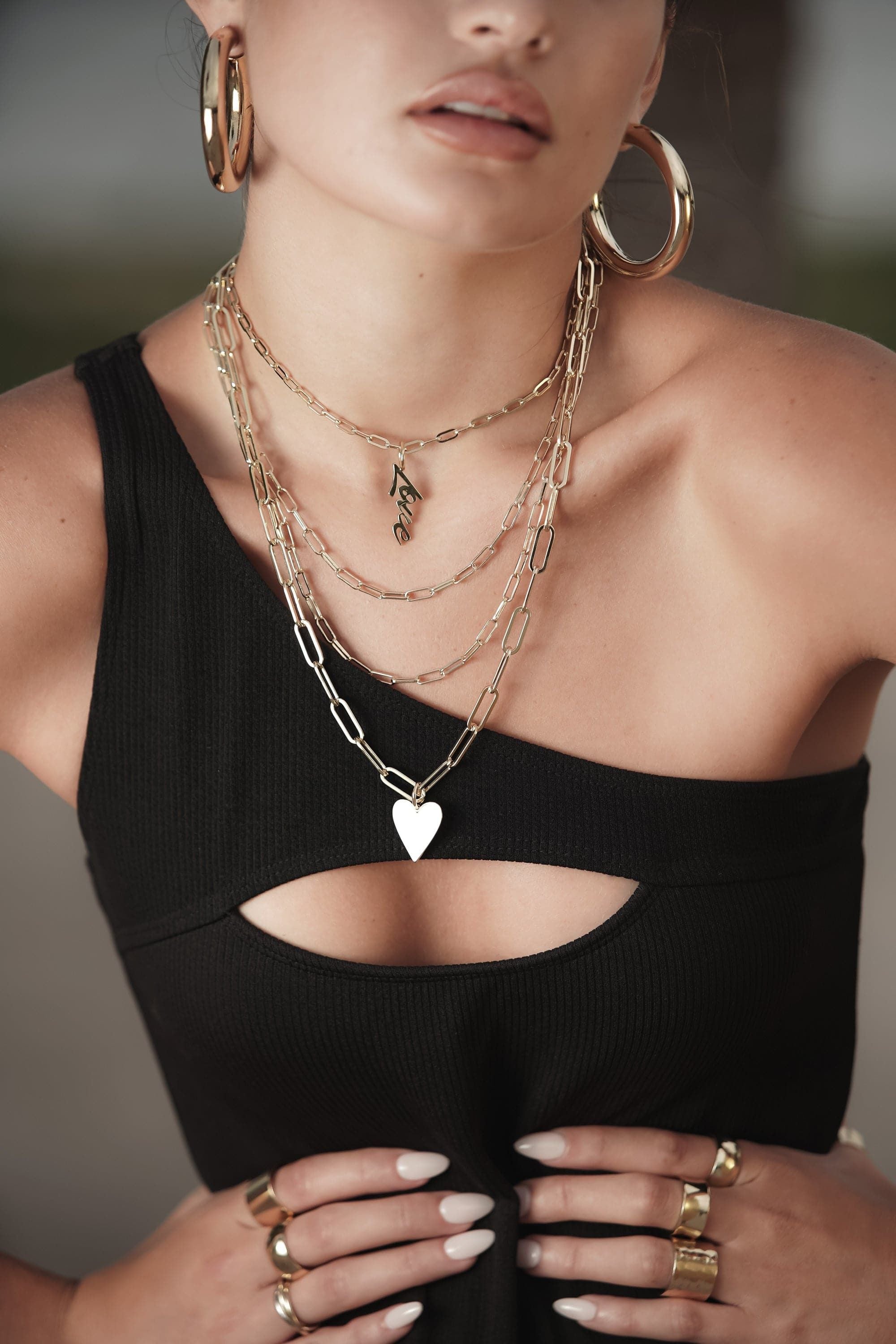 Woman showcasing the Medium Enamel Helena Pendant on an elongated link chain