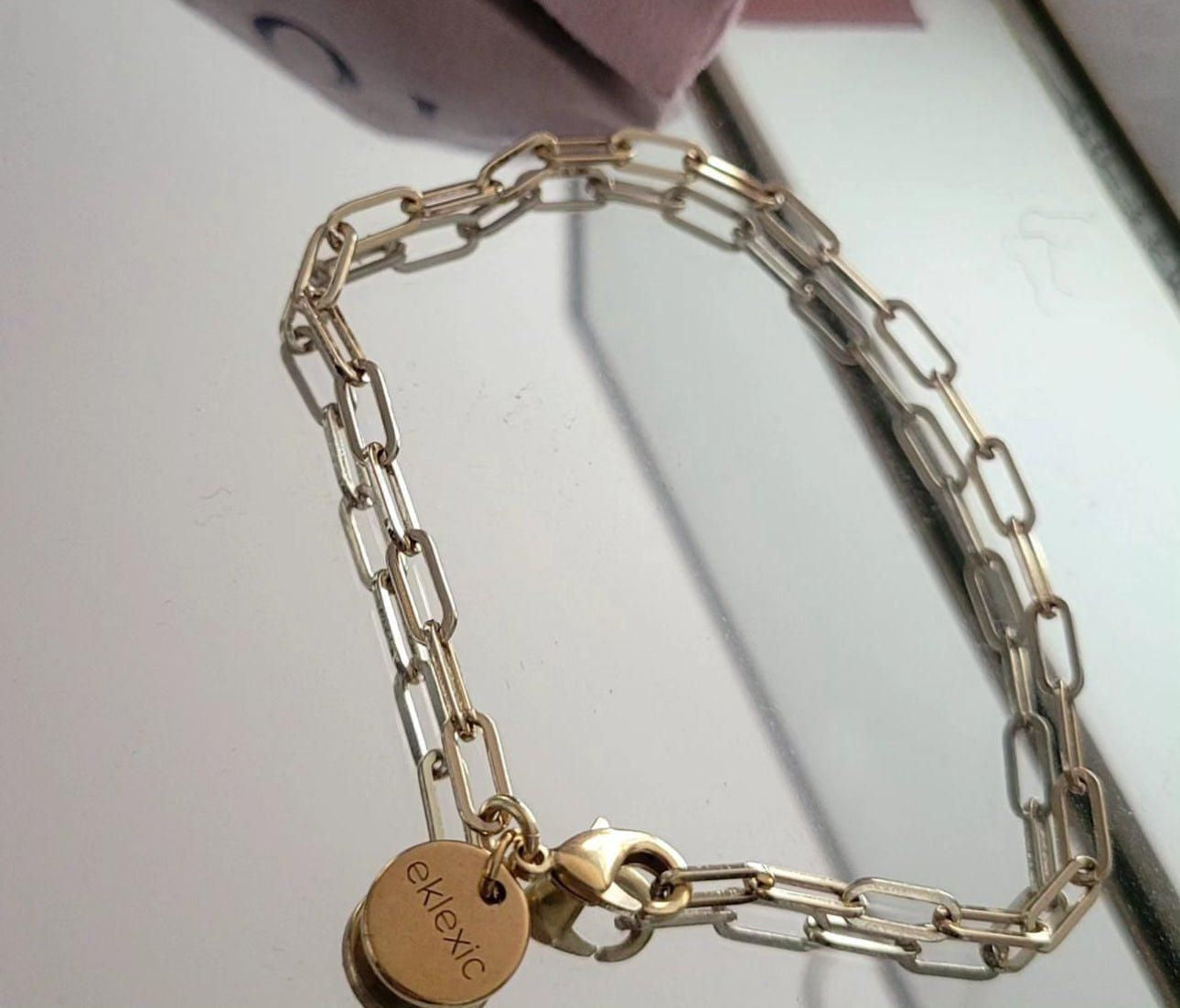 Gold chain bracelet made of recycled brass with a circular charm in 14k gold