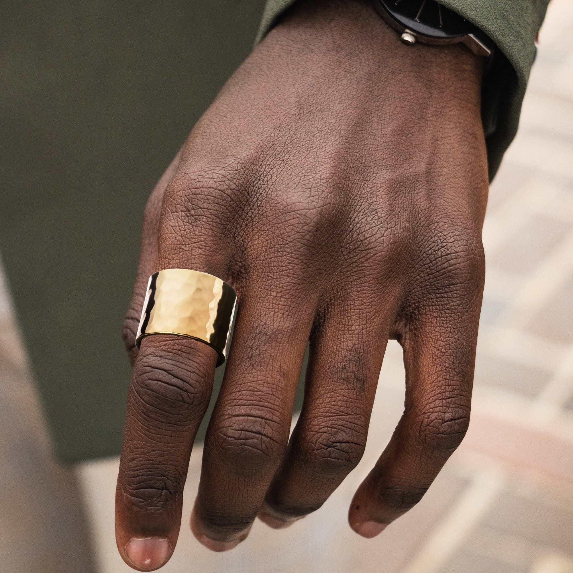 Gold hammered ring featuring a hammered texture in a 1 inch wide recycled brass ring