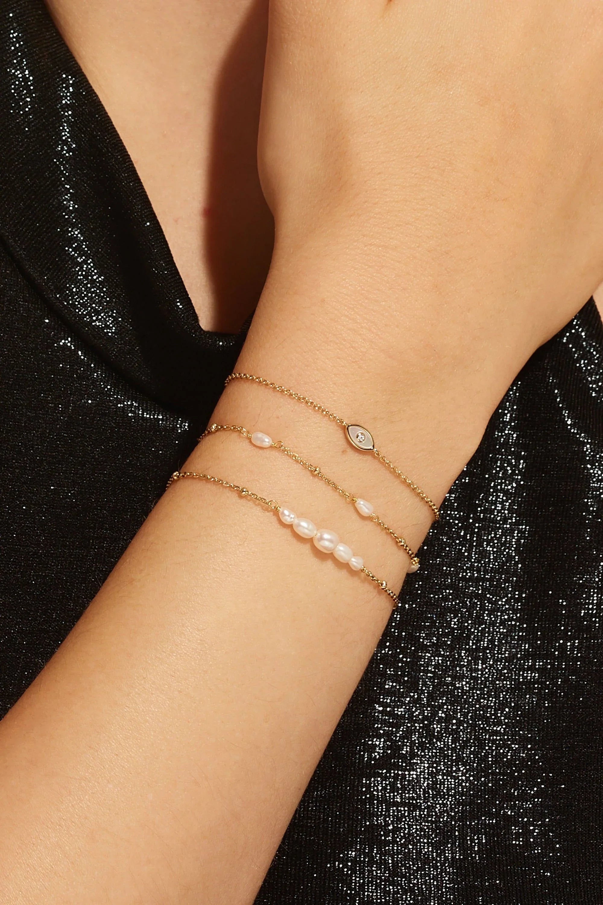 Gold chain bracelets with pearls and gemstones, perfect for the Micro Clustered Pearl & Bead Bracelet
