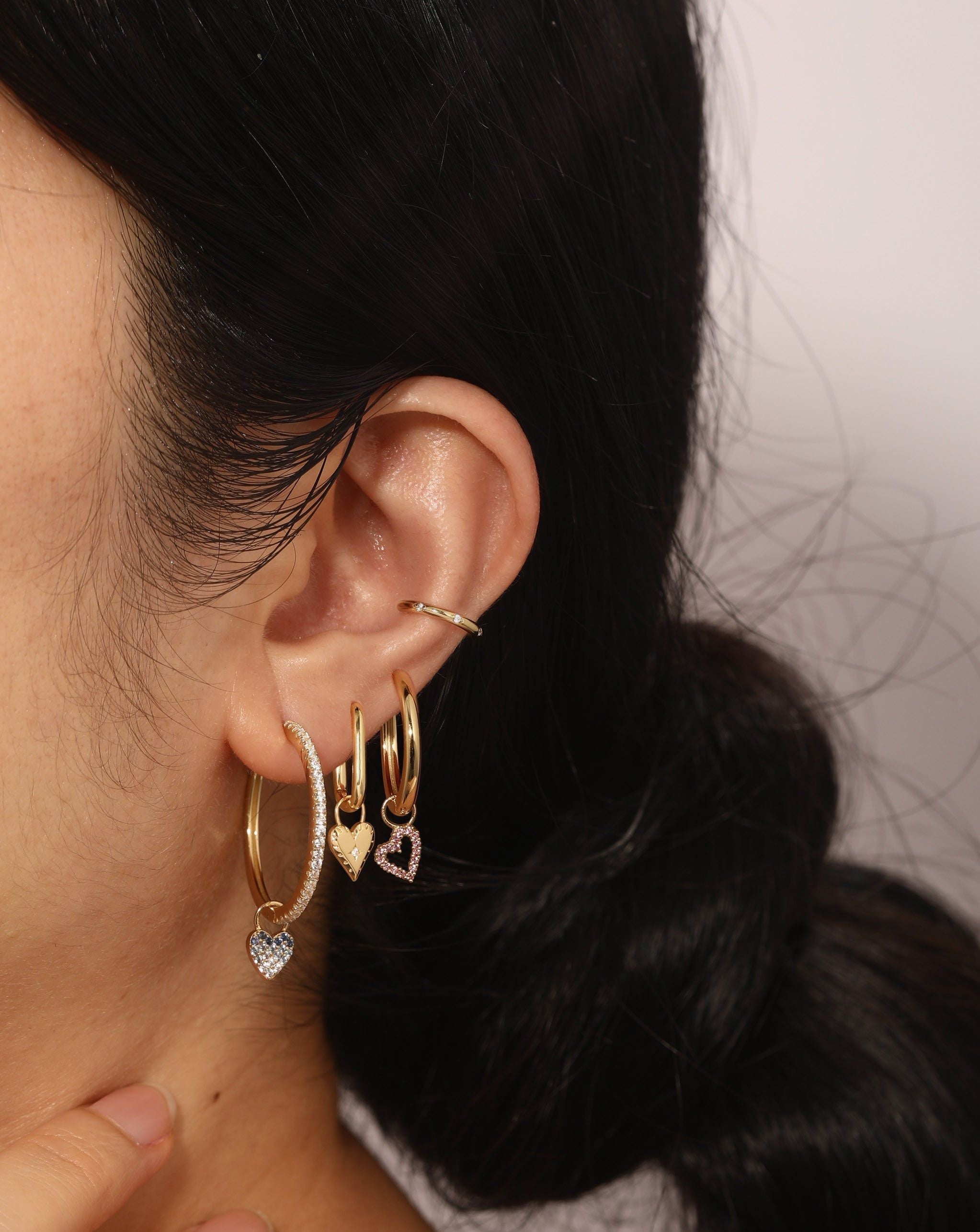 Ear featuring Open Heart Hoop Charm in 14k gold vermeil with hoop earring charms