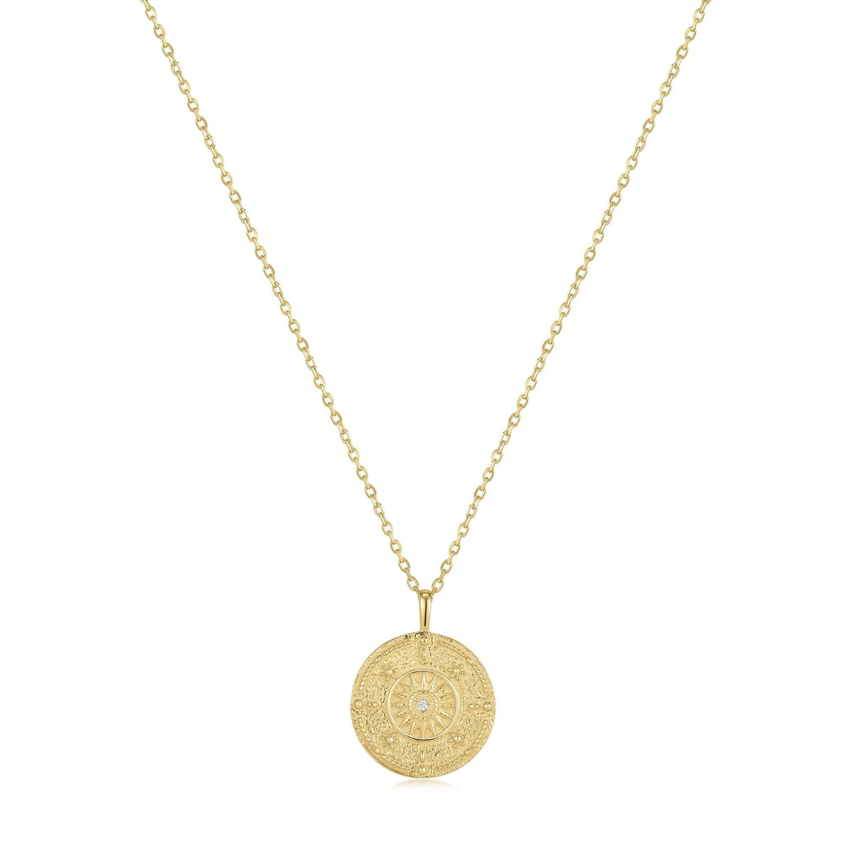 Gold chain necklace with round engraved medallion pendant featuring CZ center stone