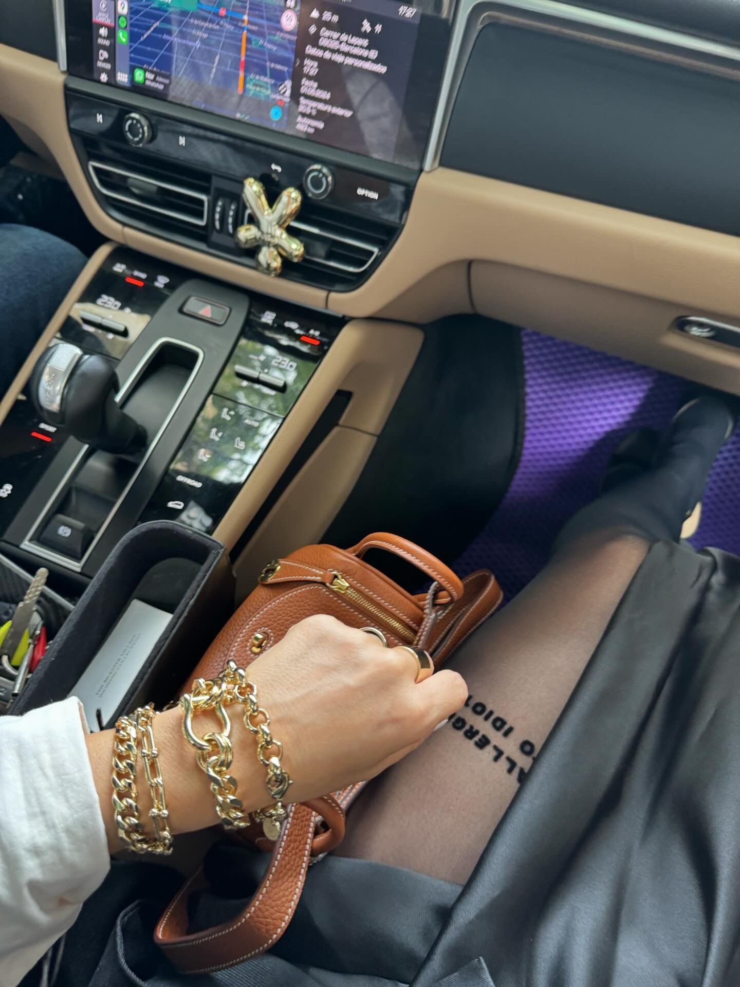 Gold chain bracelets with a brown leather purse featuring the Royal Bracelet in 14k gold