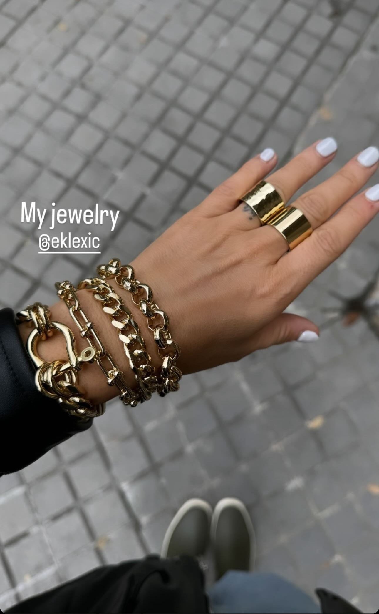 Gold jewelry on a hand showcasing the elegant Royal Bracelet made of recycled brass and 14k gold