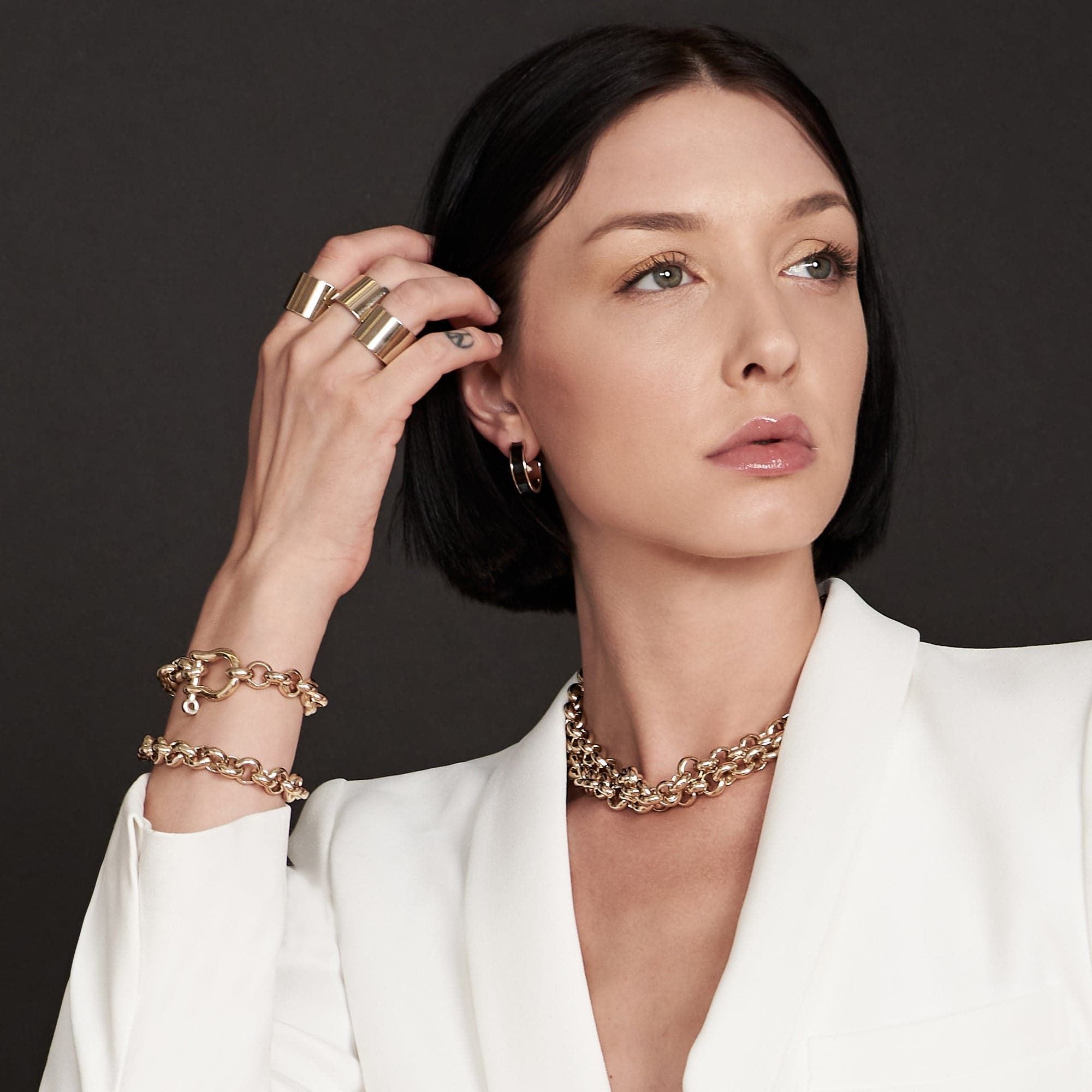 Woman showcasing the Royal Bracelet made of recycled brass and 14k gold