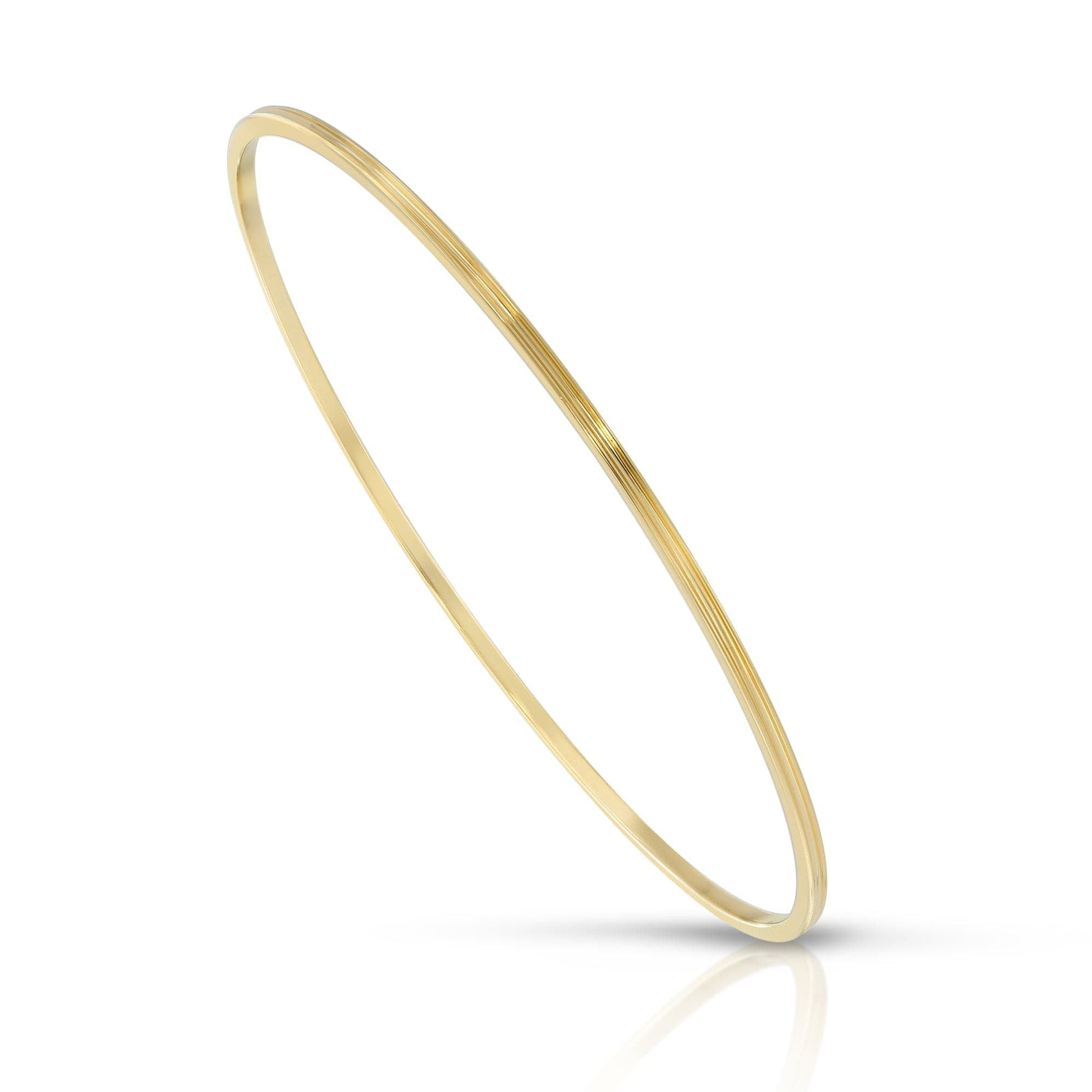 Thin gold Skinny Lily Bangle made from recycled brass, perfect for eco-conscious fashion