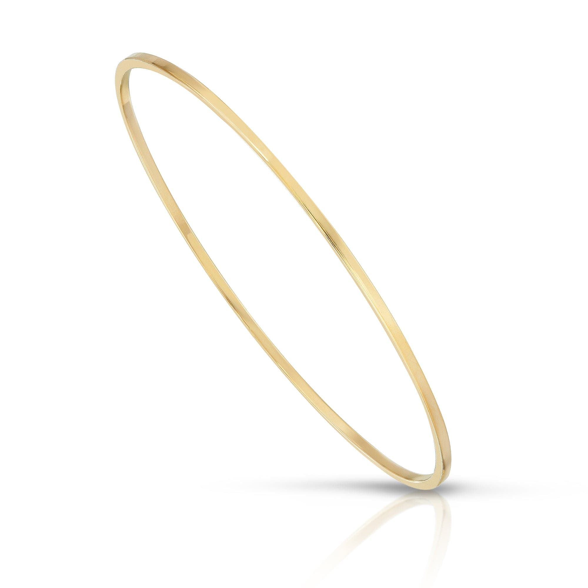 Thin gold bangle featuring the Skinny Stella Bangle design crafted from brass wire