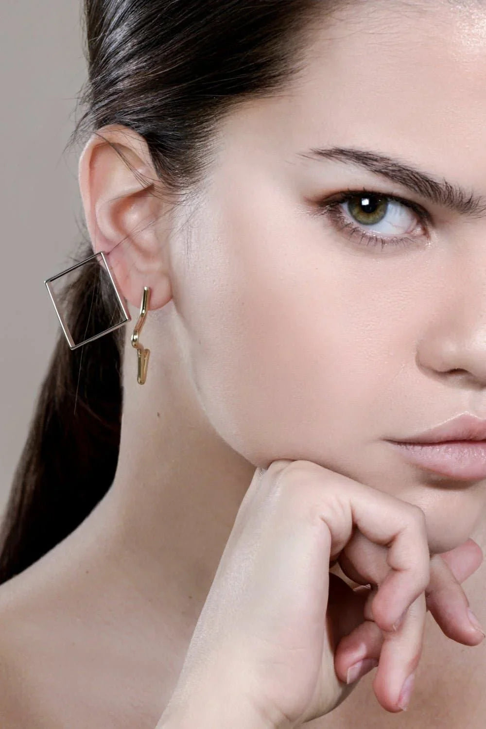 Woman wearing stylish small 1/2 star geometric earrings for a chic look