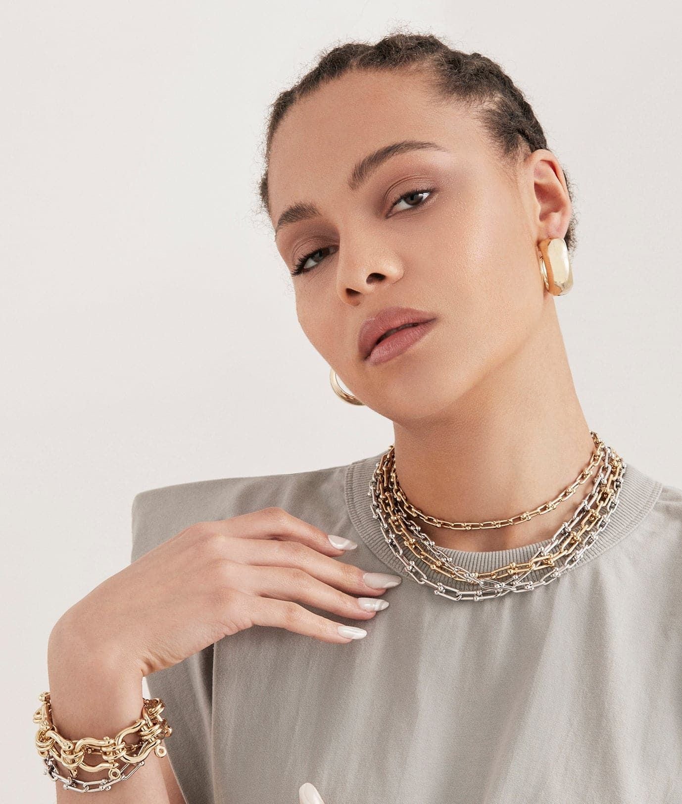 Woman showcasing the Small Margaux Necklace in 14k gold stylishly