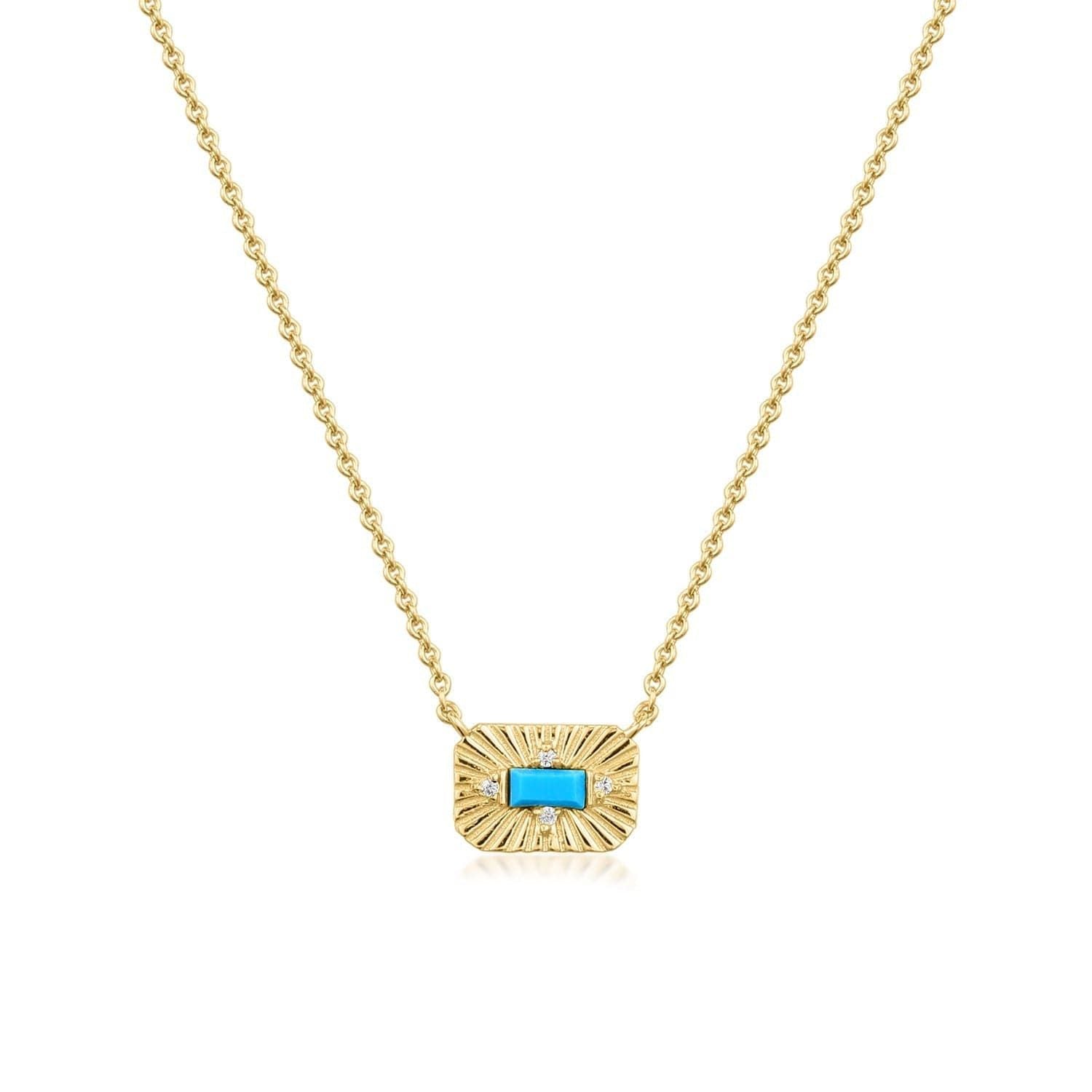 14k Gold Plated Small Starburst Pendant with Turquoise Stone Necklace on display