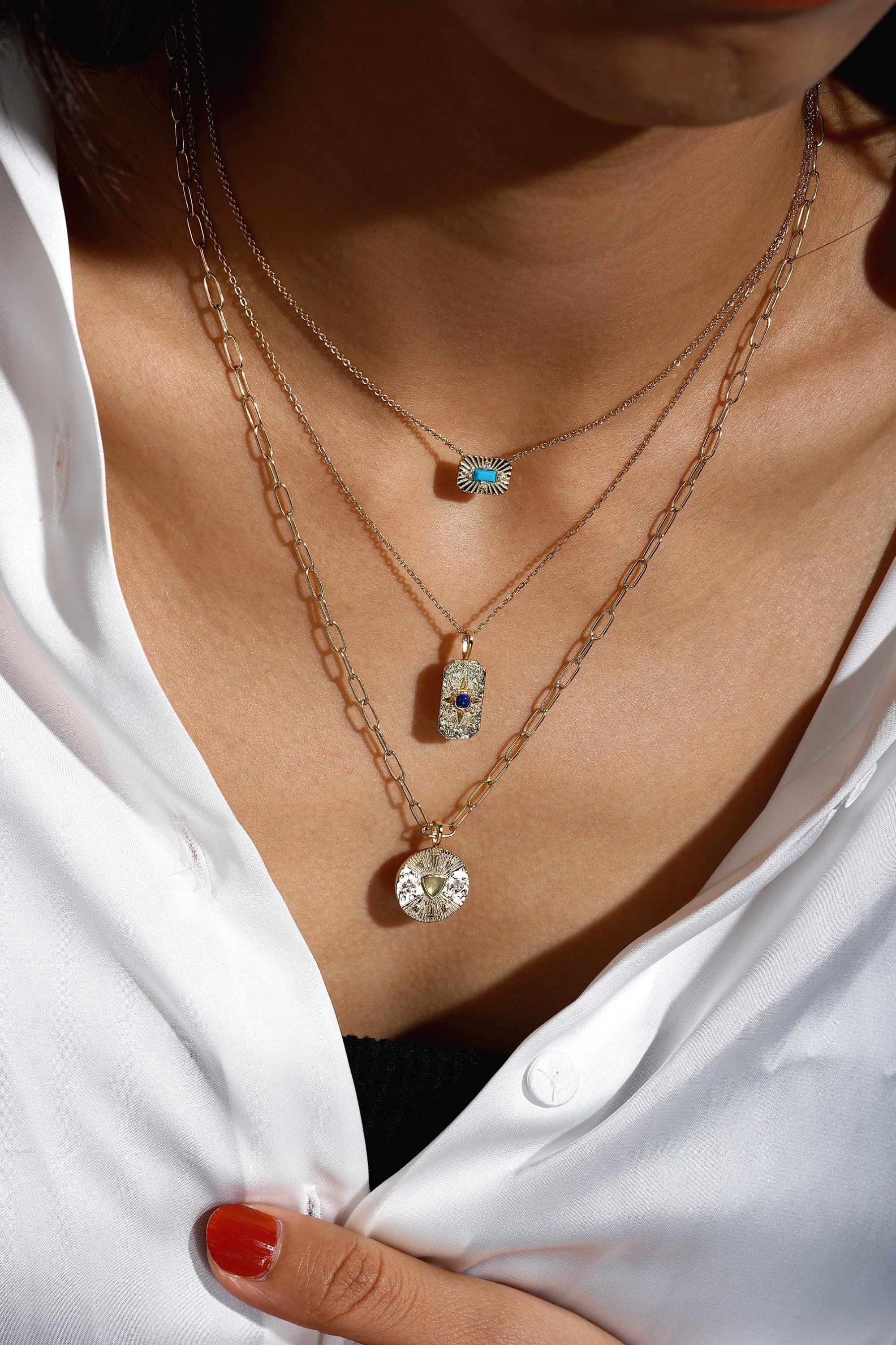 Layered 14k gold plated necklaces featuring a Small Starburst Pendant with Turquoise Stone