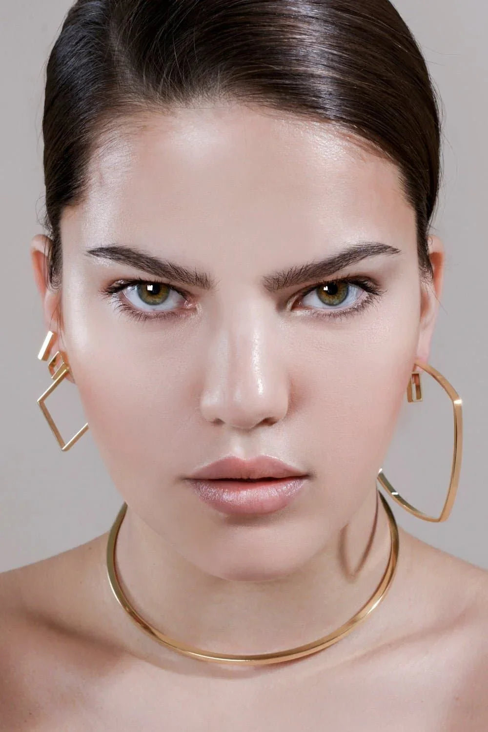 Woman wearing stylish square shaped hoops gold jewelry for a chic look