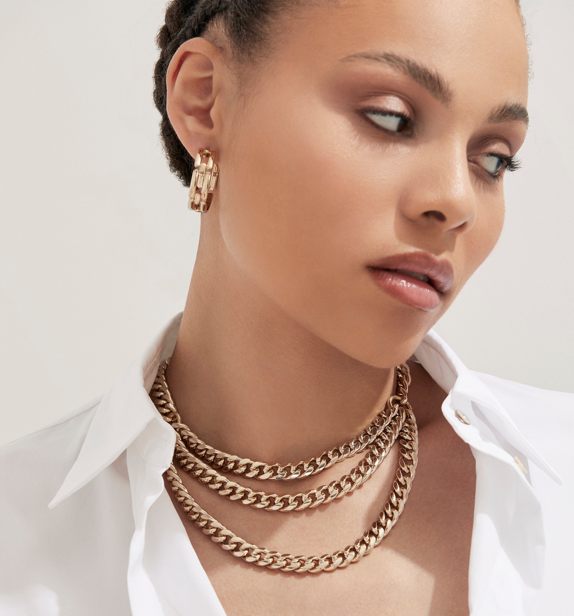 Triple layer curb chain necklace in recycled brass featuring elegant gold chains