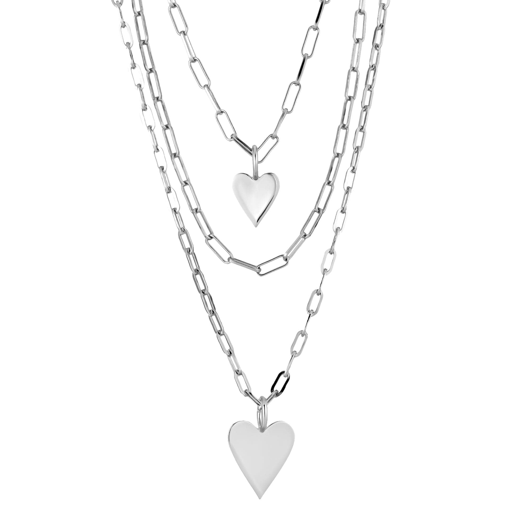 Layered silver heart necklaces featuring elongated link chains and medium Helena pendants