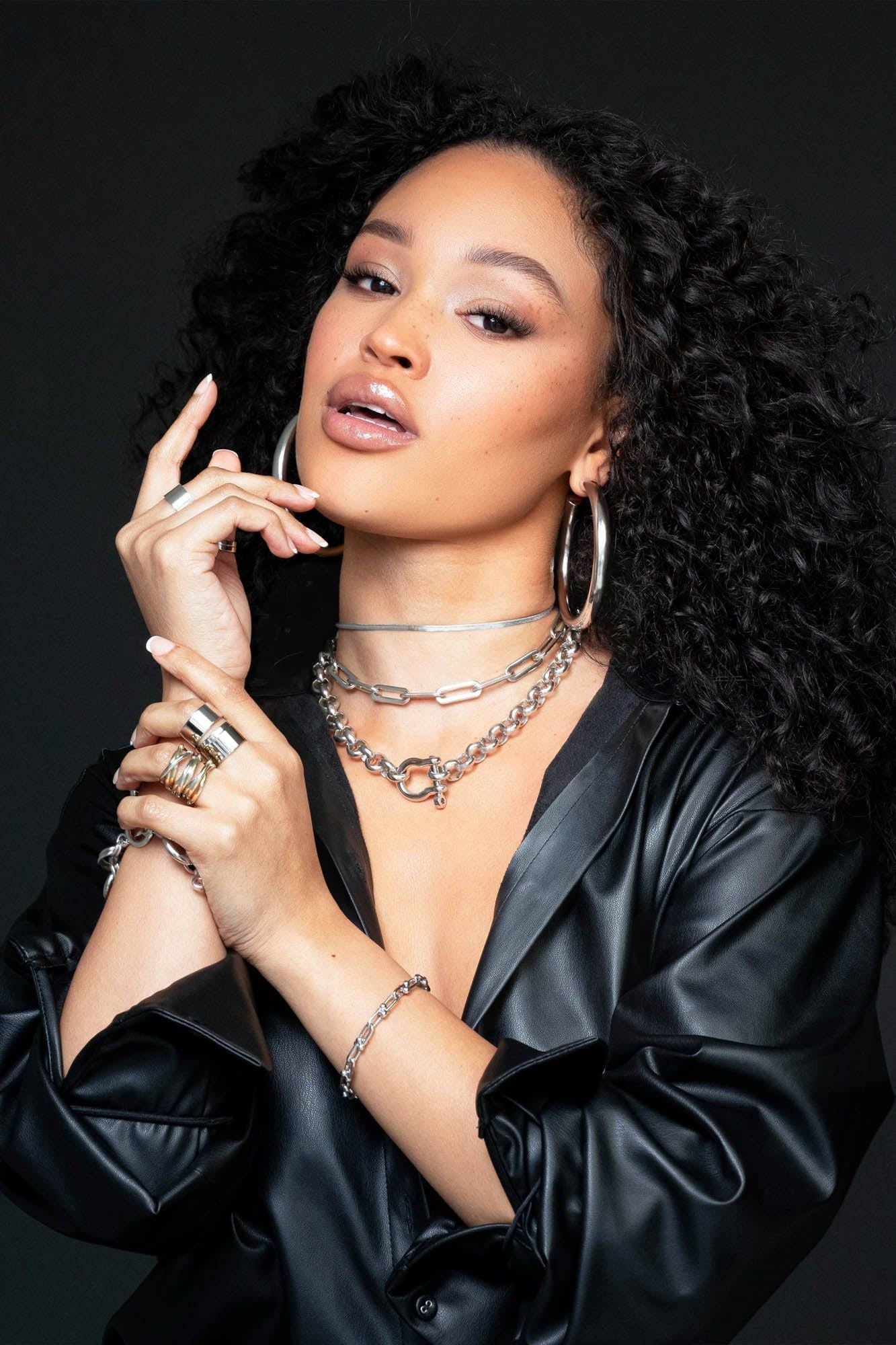 Woman showcasing the Two Toned Triple Domed Roll Ring with silver jewelry